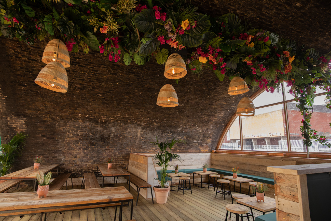 Stylish event space with arched ceiling and floral decor in Pergola Brixton.