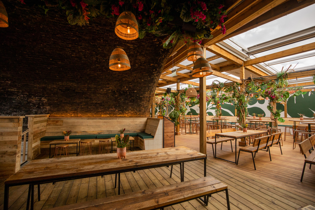 Stylish event space with rustic wood and skylights, ideal for gatherings and workshops.