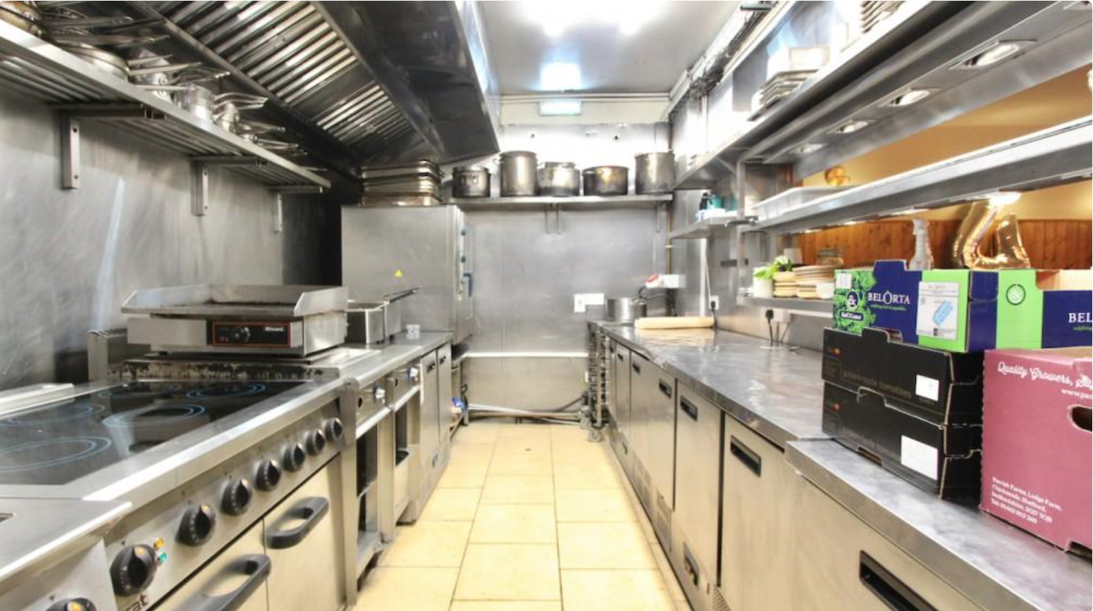 Commercial kitchen with stainless steel surfaces for efficient event catering.
