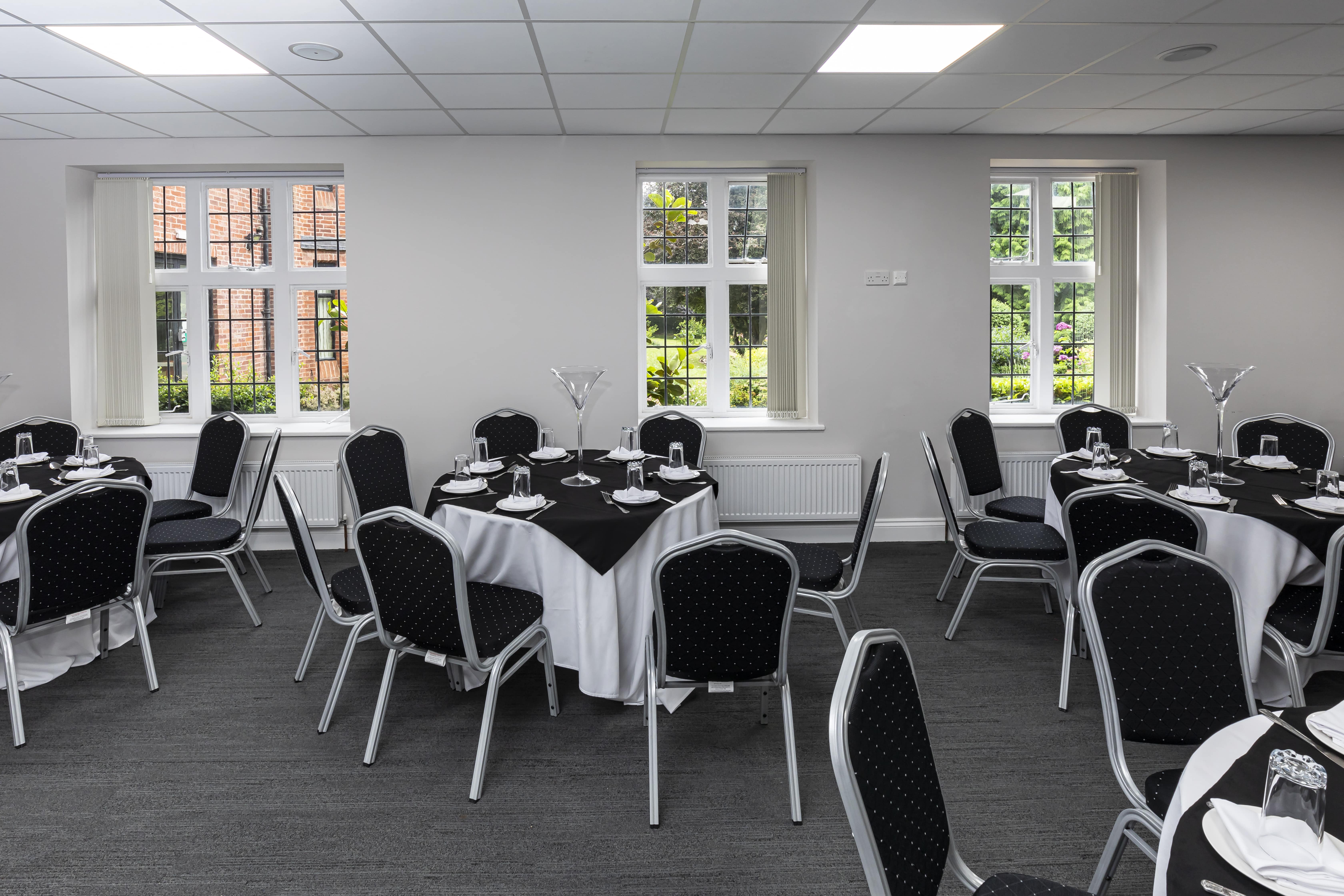Elegant conference room with round tables, ideal for meetings and events.