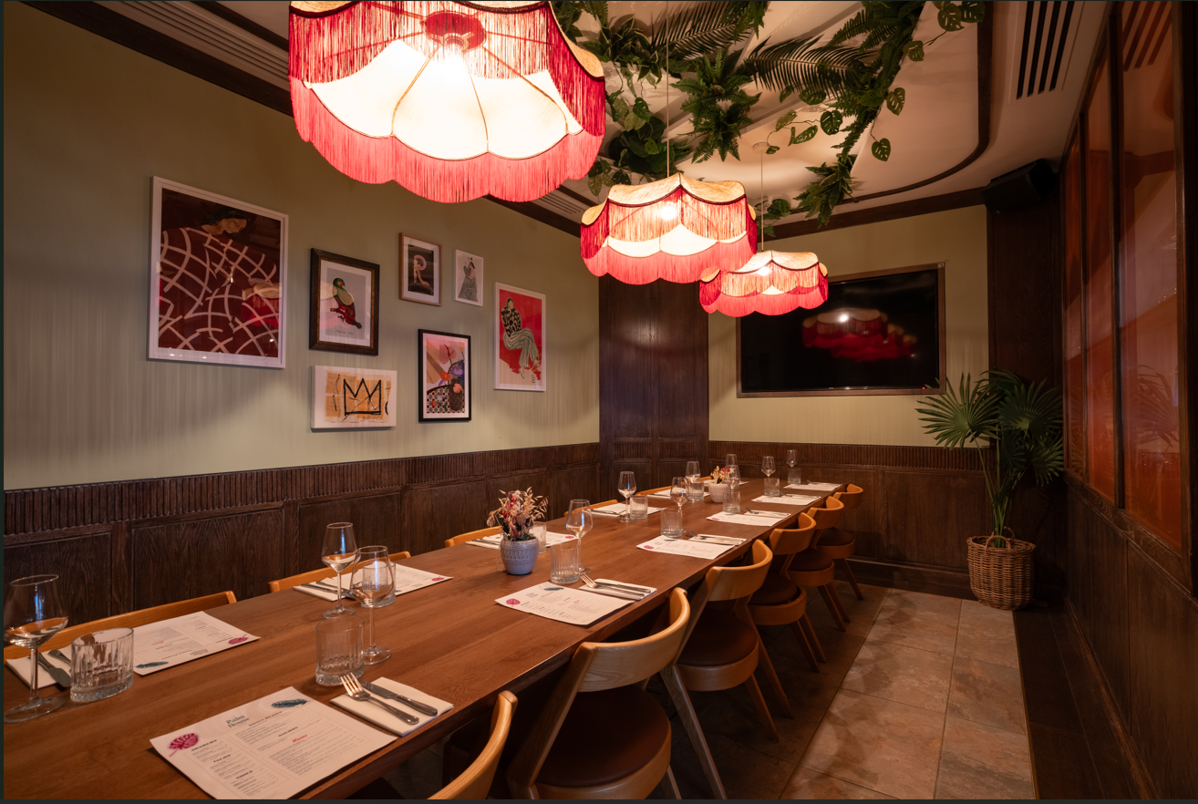 Private dining room with wooden table, ideal for intimate meetings and events.