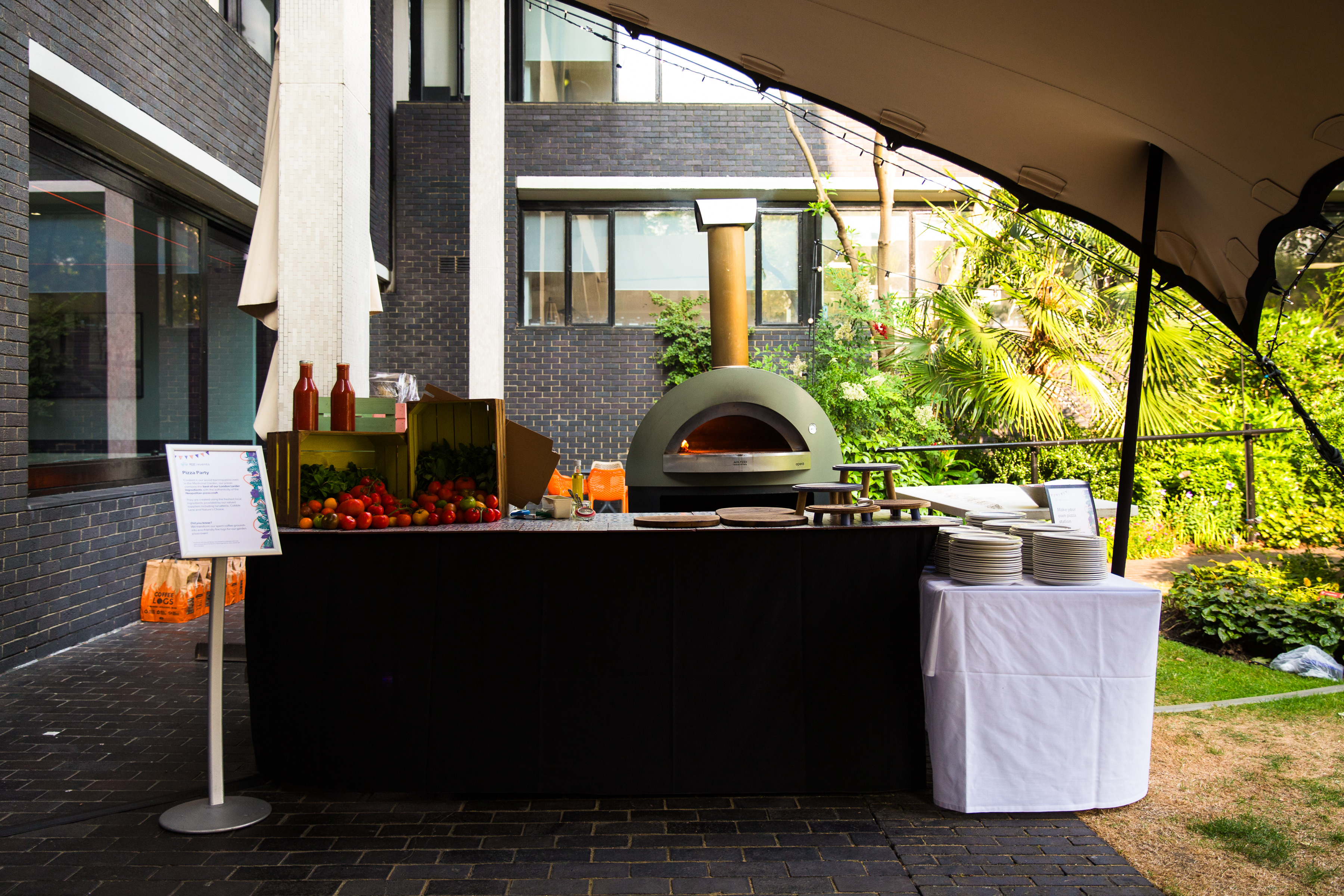 Outdoor catering setup with pizza oven in Medicinal Garden, RCP London Events.