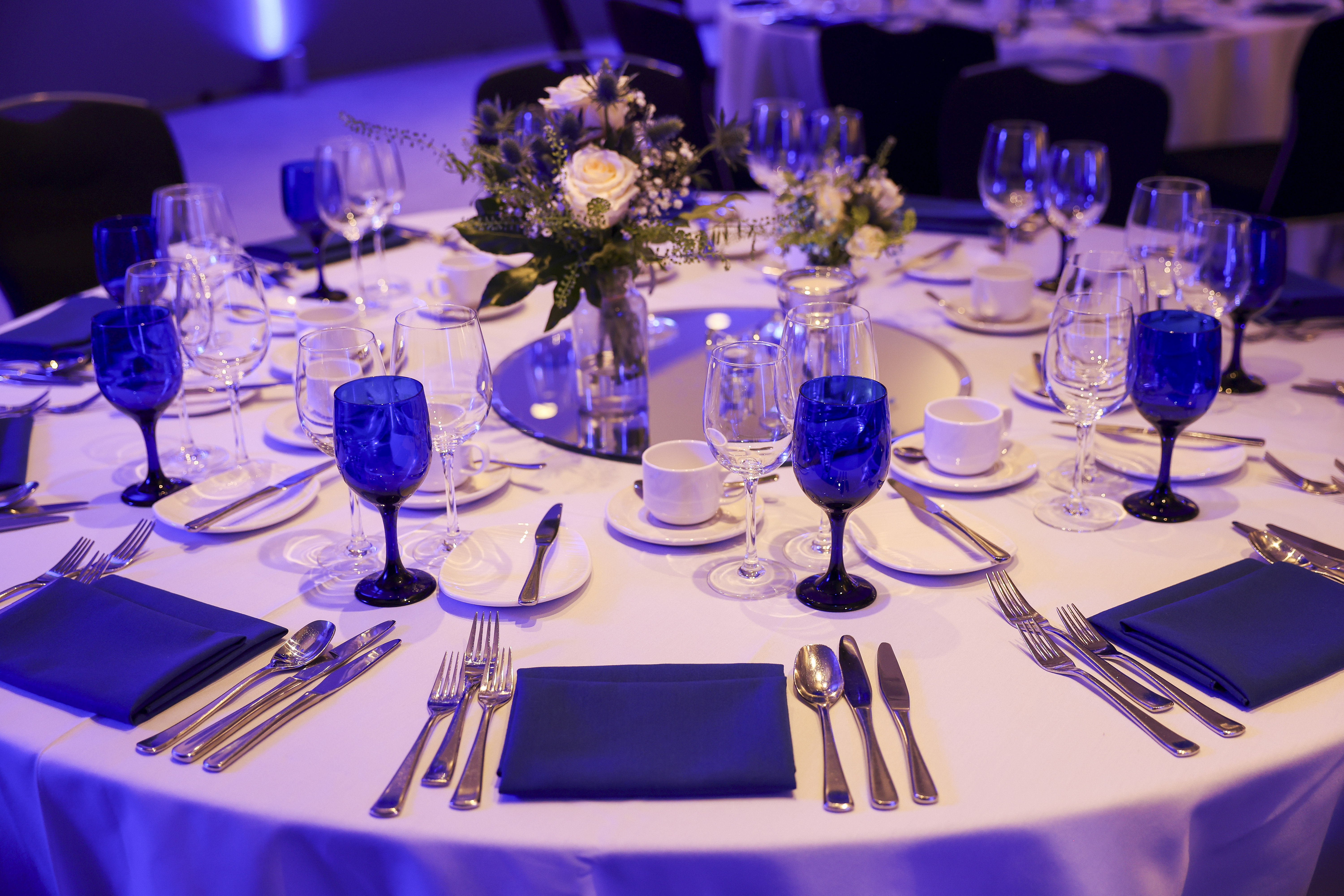Elegant banquet table with blue glassware in RCP London Events for corporate gatherings.