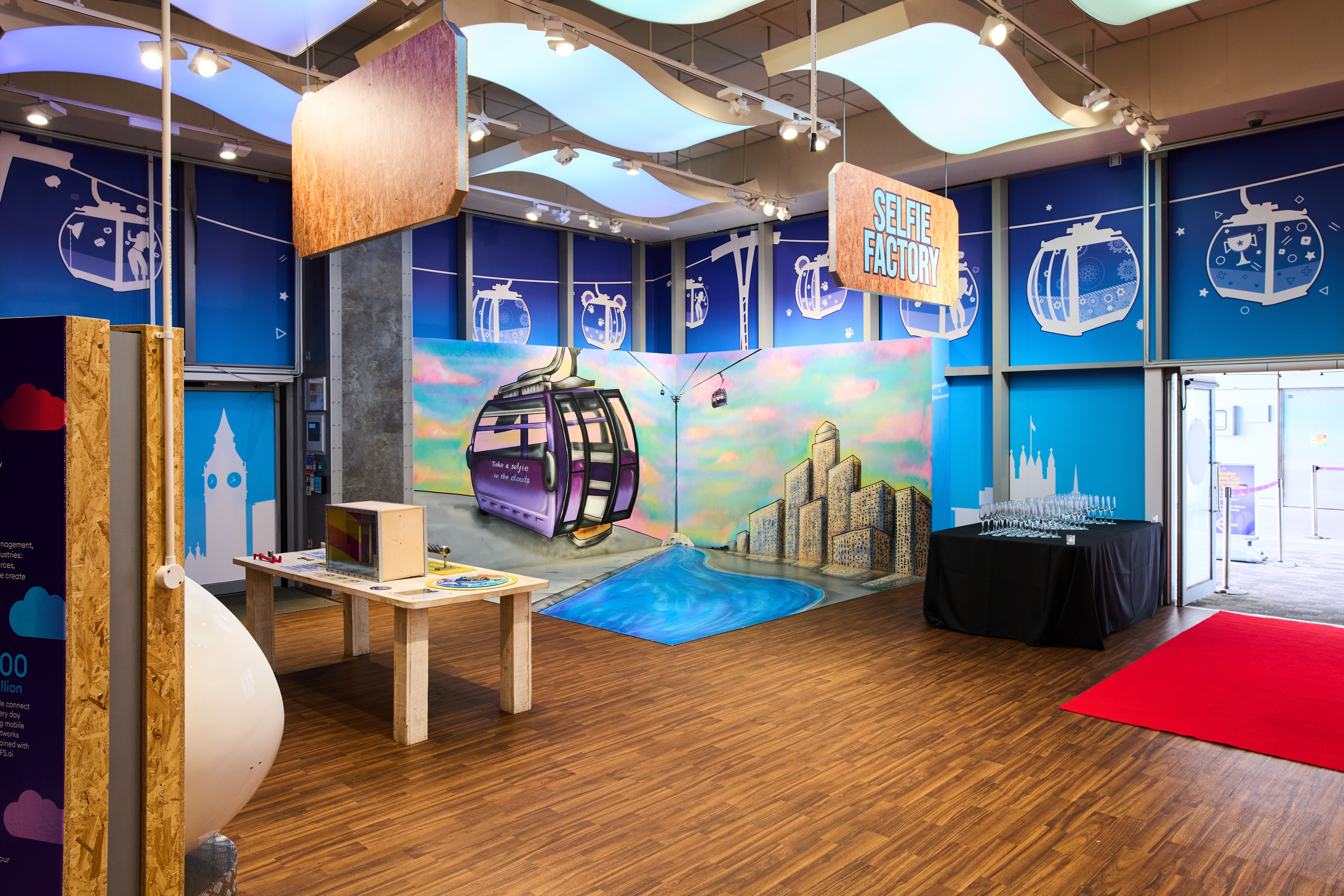 Alt text: London Cable Car Main Hall event space with colorful gondola theme and sleek flooring.