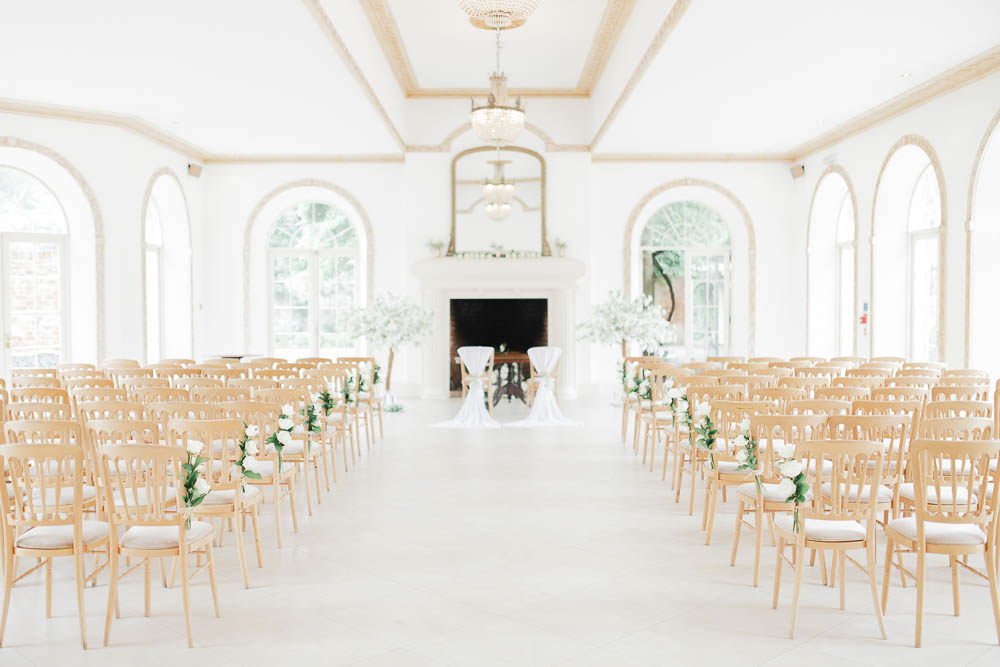 Elegant wedding ceremony setup in Vine Room, Northbrook Park with floral accents.