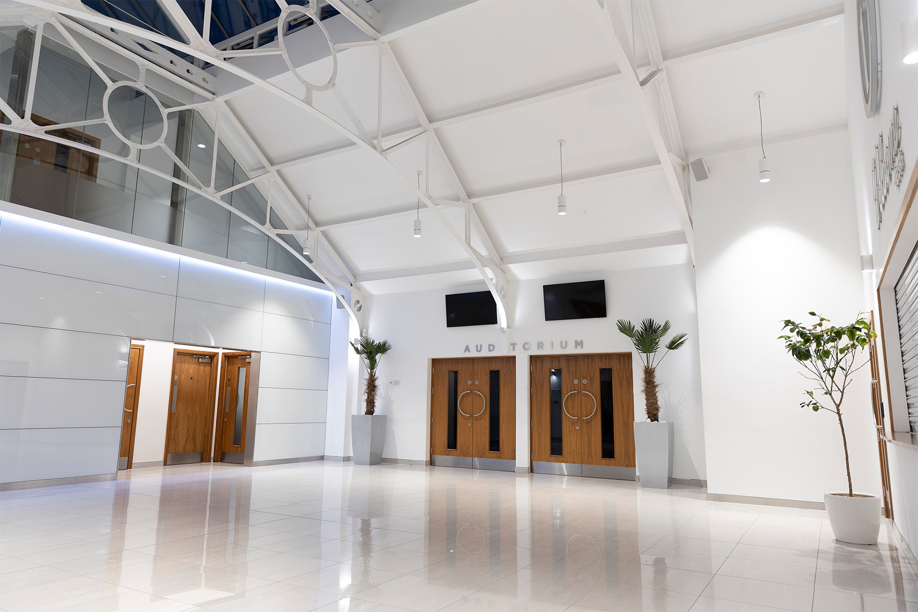 Modern Tab Centre Auditorium foyer with high ceilings, ideal for events and networking.