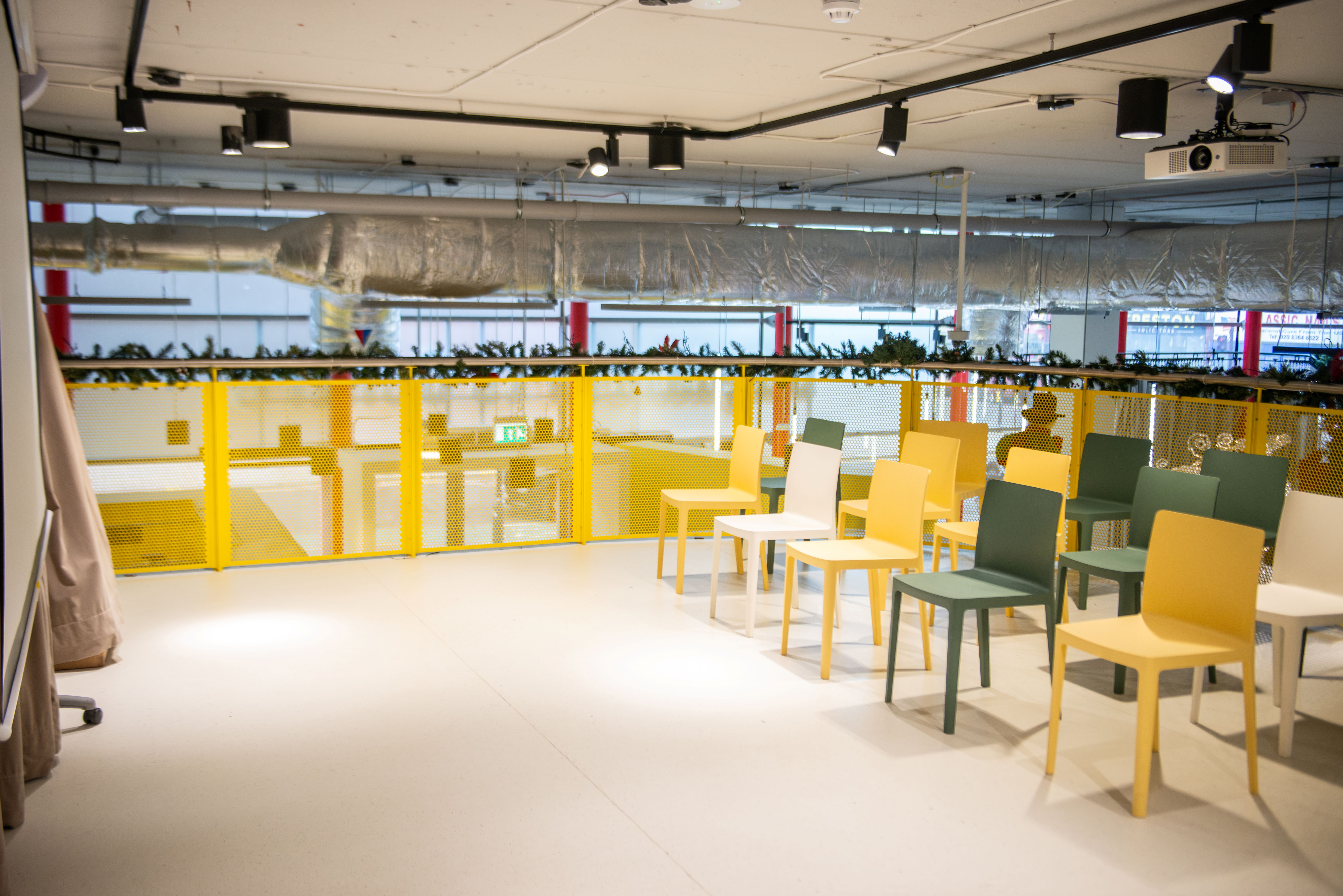 Minerva Mezzanine at Dugdale Arts Centre: modern event space with colorful chairs for workshops.