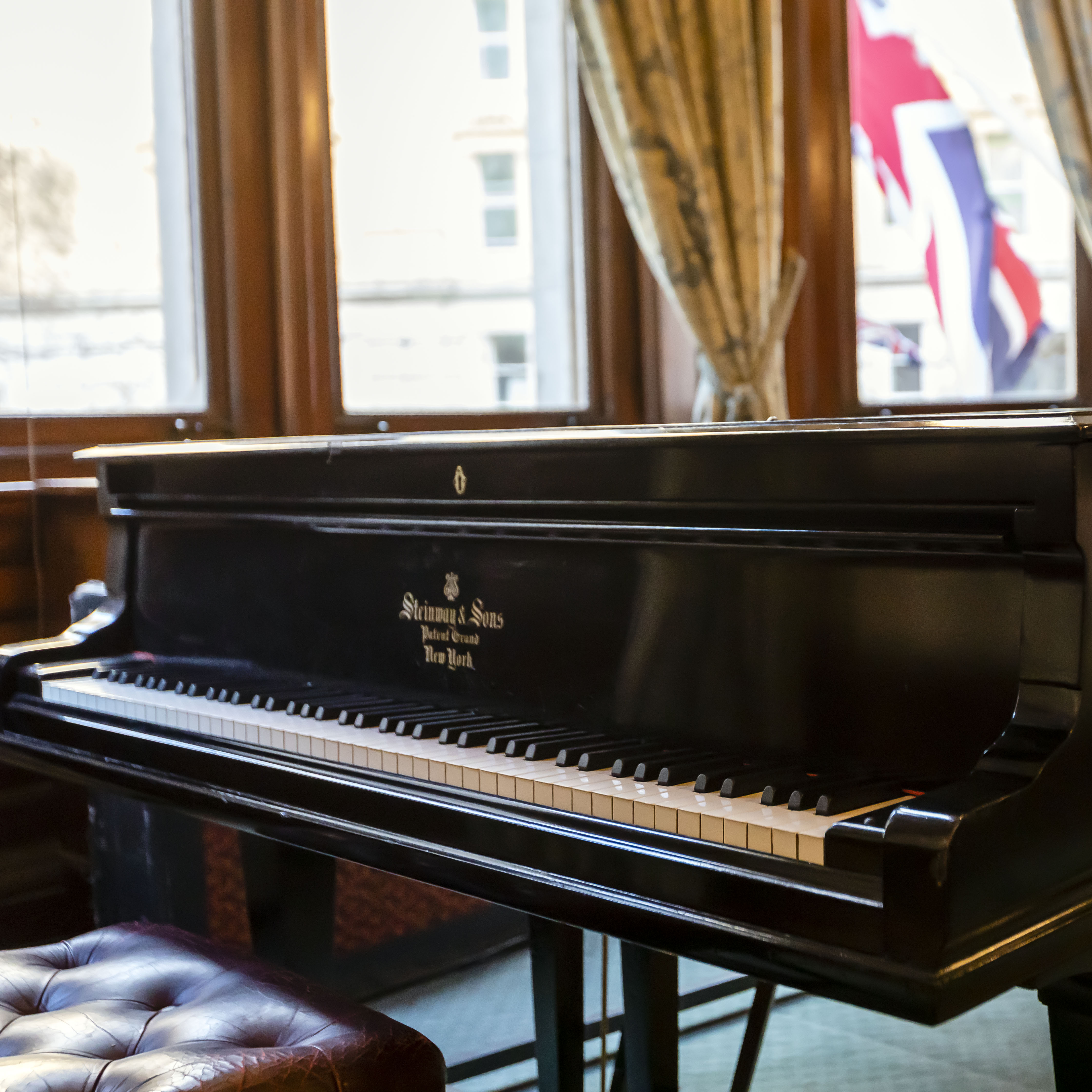 David Lloyd George Room with grand piano, ideal for live music events and receptions.