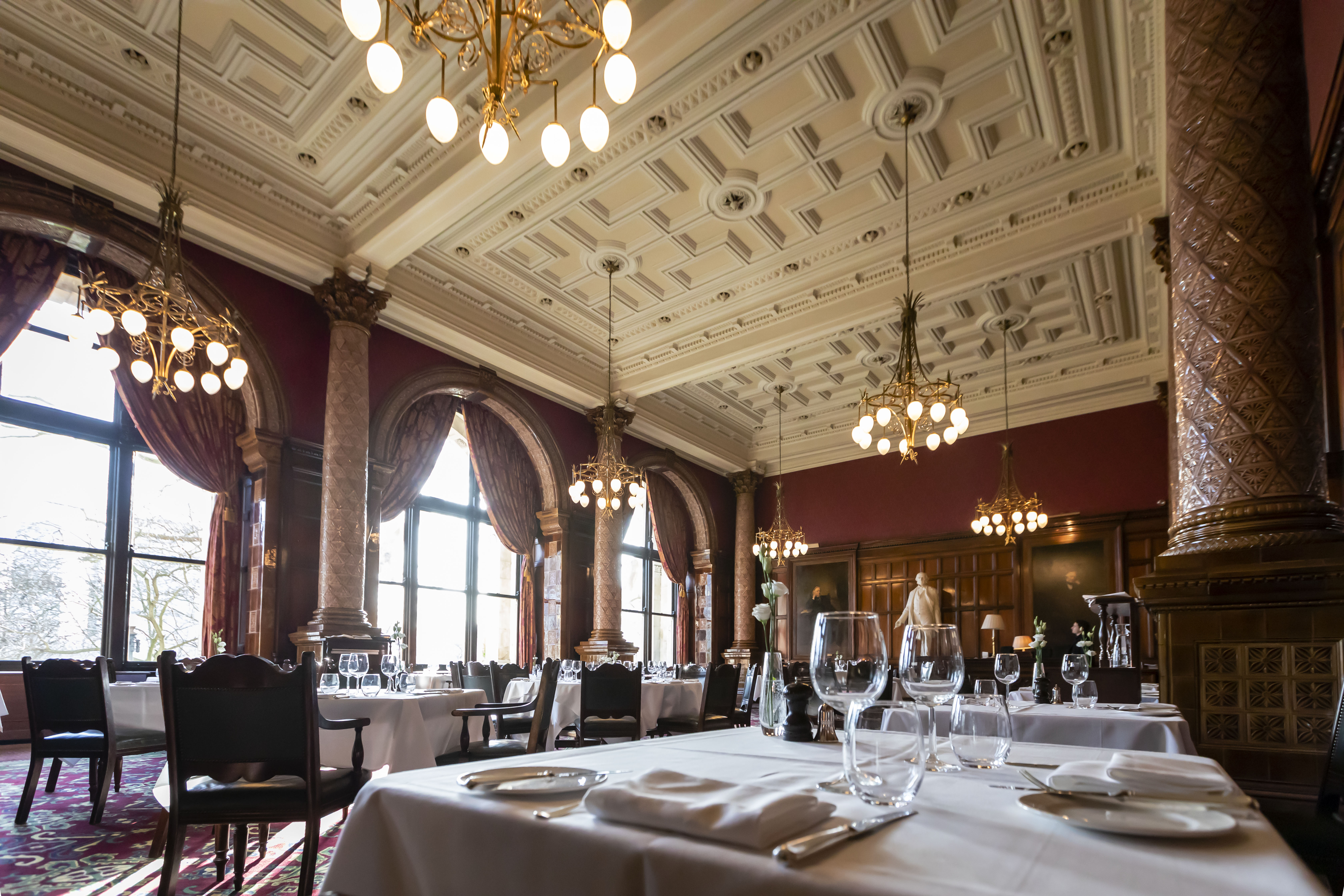 Elegant dining room with ornate ceiling, ideal for corporate dinners and exclusive receptions.