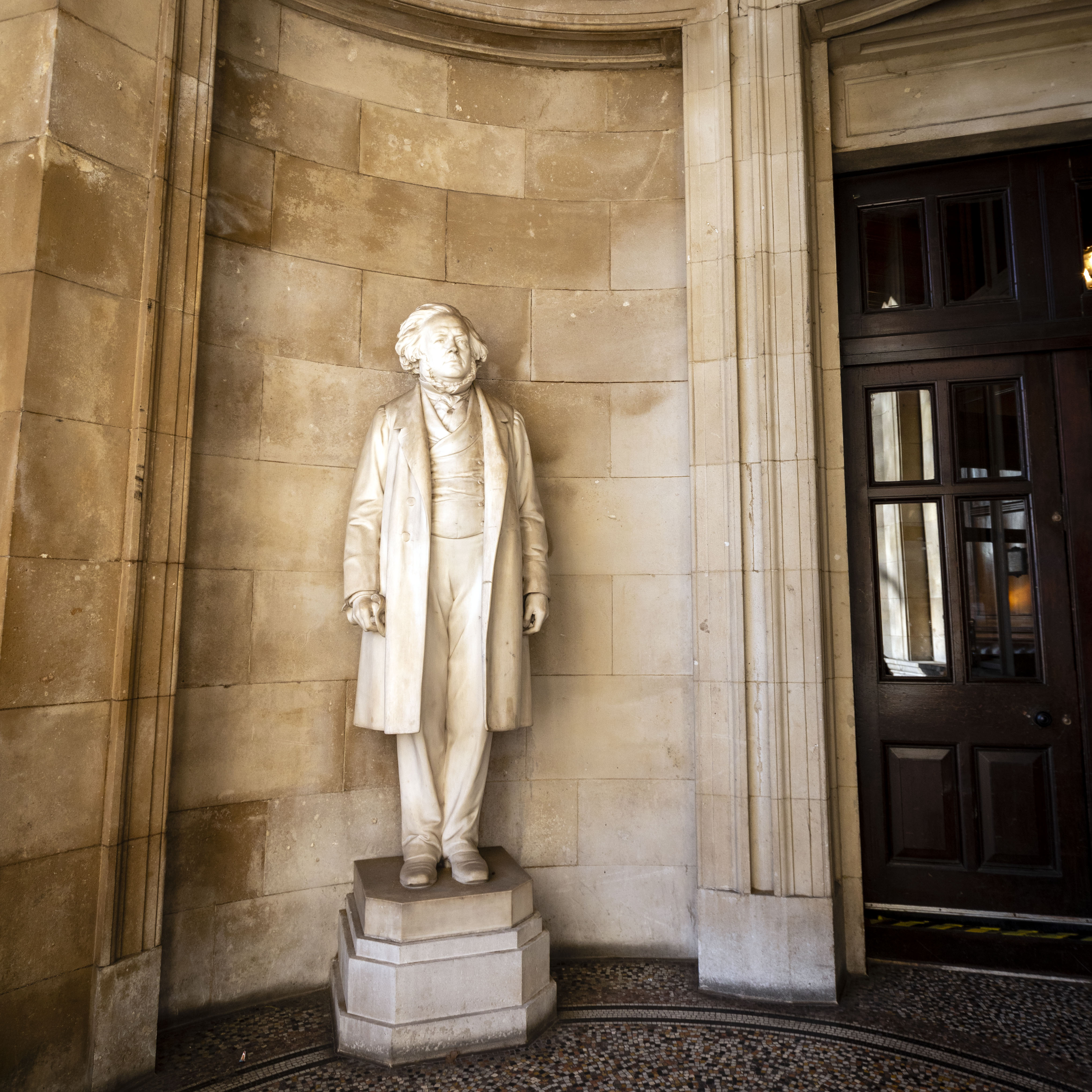 Elegant interior of The National Liberal Club with a historical statue, perfect for events.