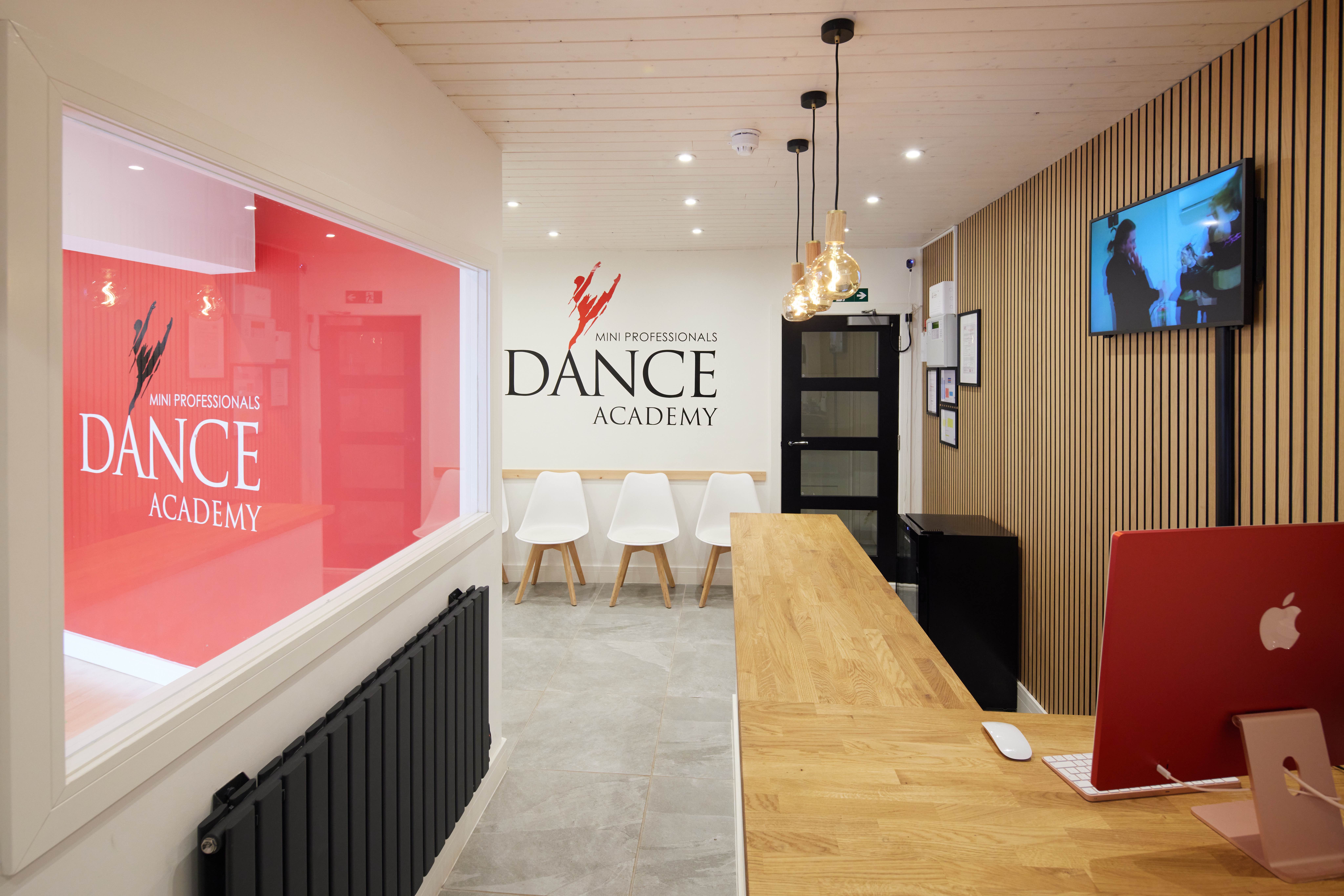 Modern dance studio reception with warm wood accents, ideal for workshops and classes.