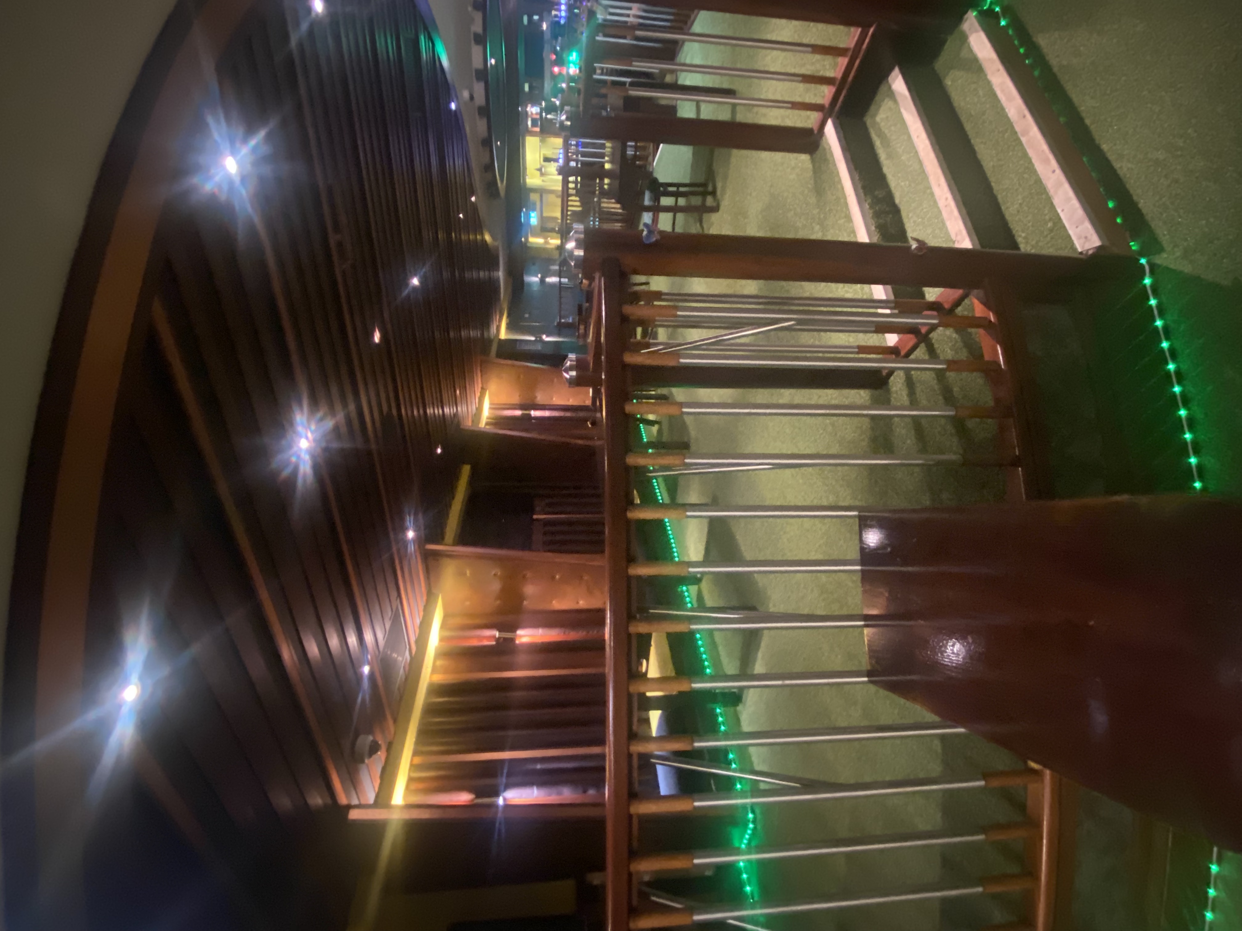 Private dining area with modern design and green LED lights for events at Carib Vibes Bar.