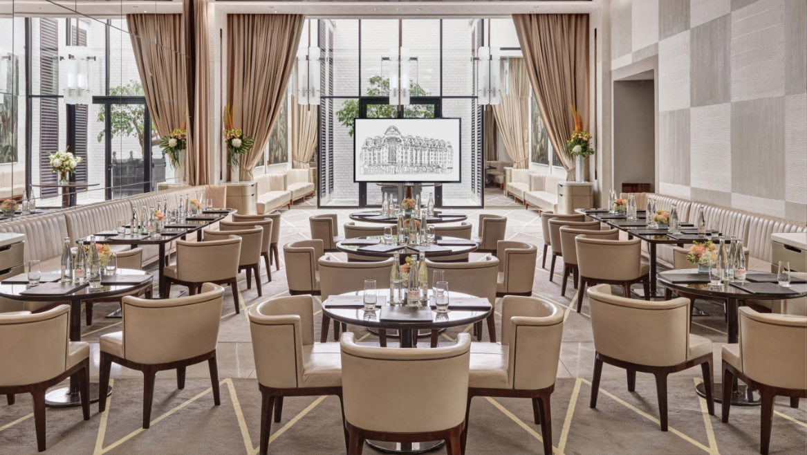 L'Orangerie event space in Paris with elegant seating and natural light for meetings.