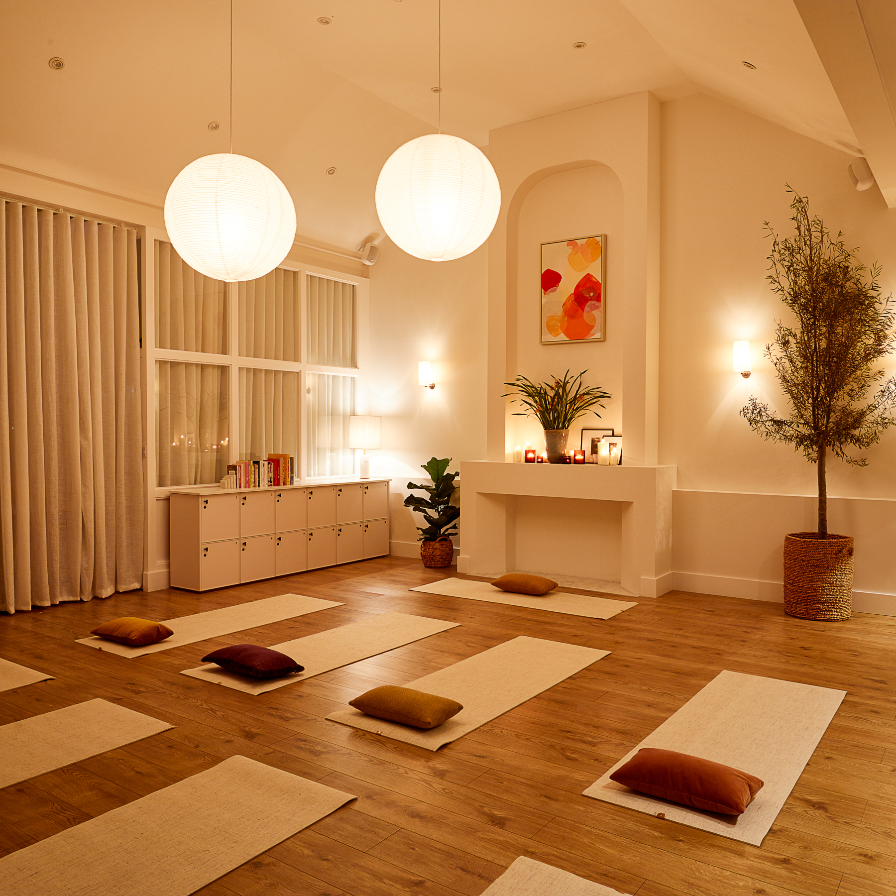 Serene yoga studio with soft lighting, ideal for wellness retreats and mindfulness workshops.