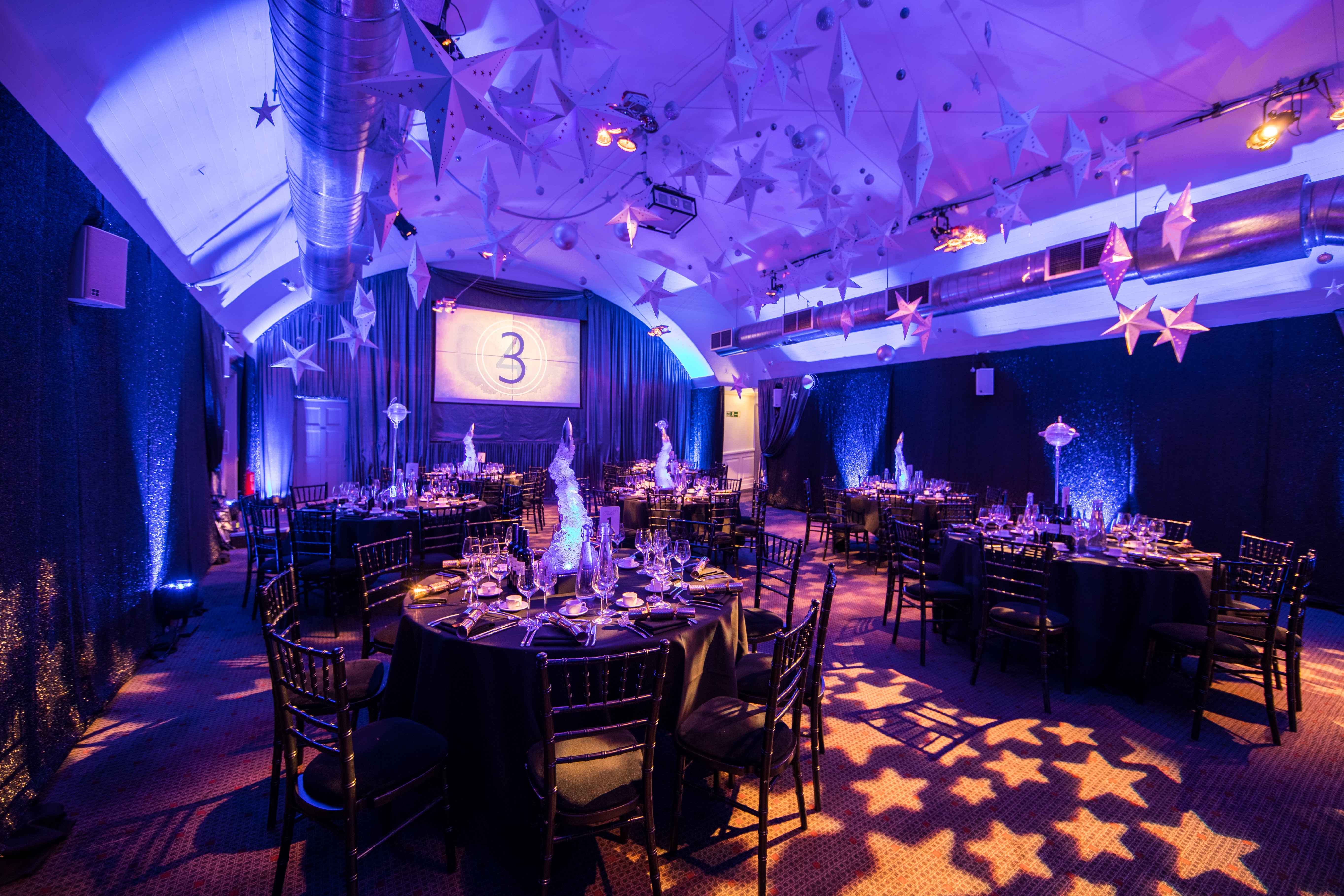 Elegant Christmas party setup with dark linens and festive decor at The Brewery.