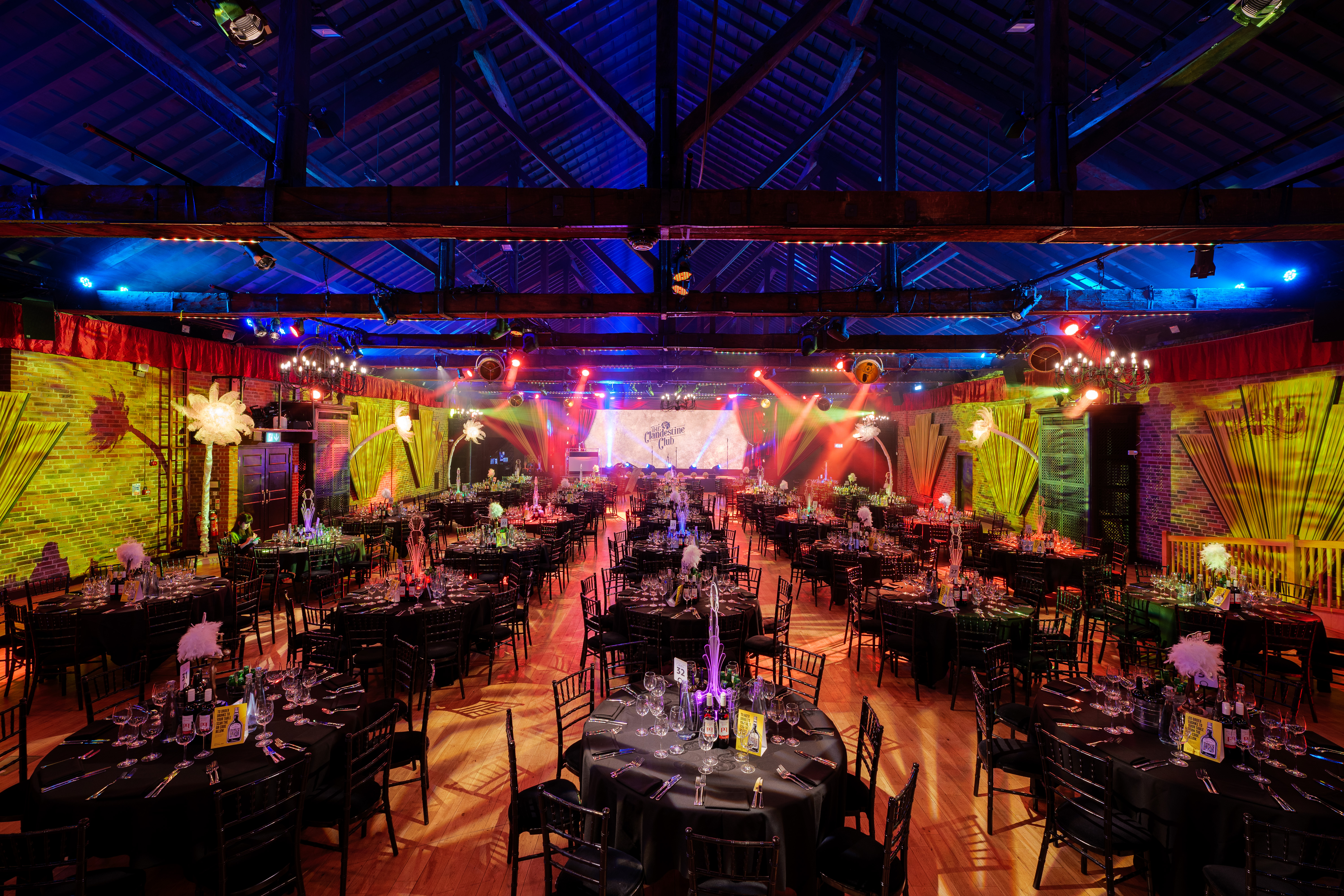 Christmas party setup at The Brewery with elegant tables and vibrant lighting.