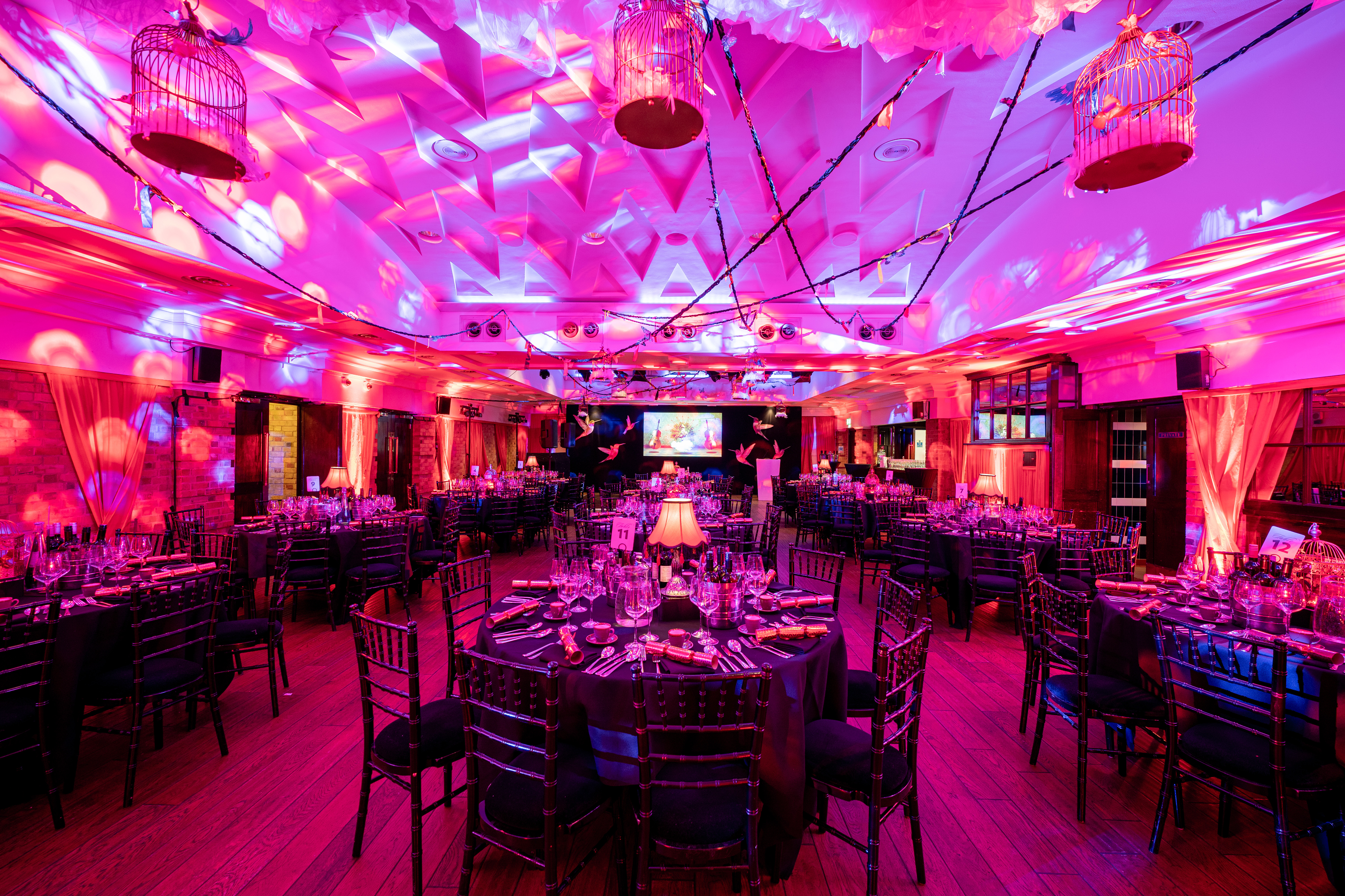 Elegant Christmas party setup with dark linens and whimsical decor at The Brewery.