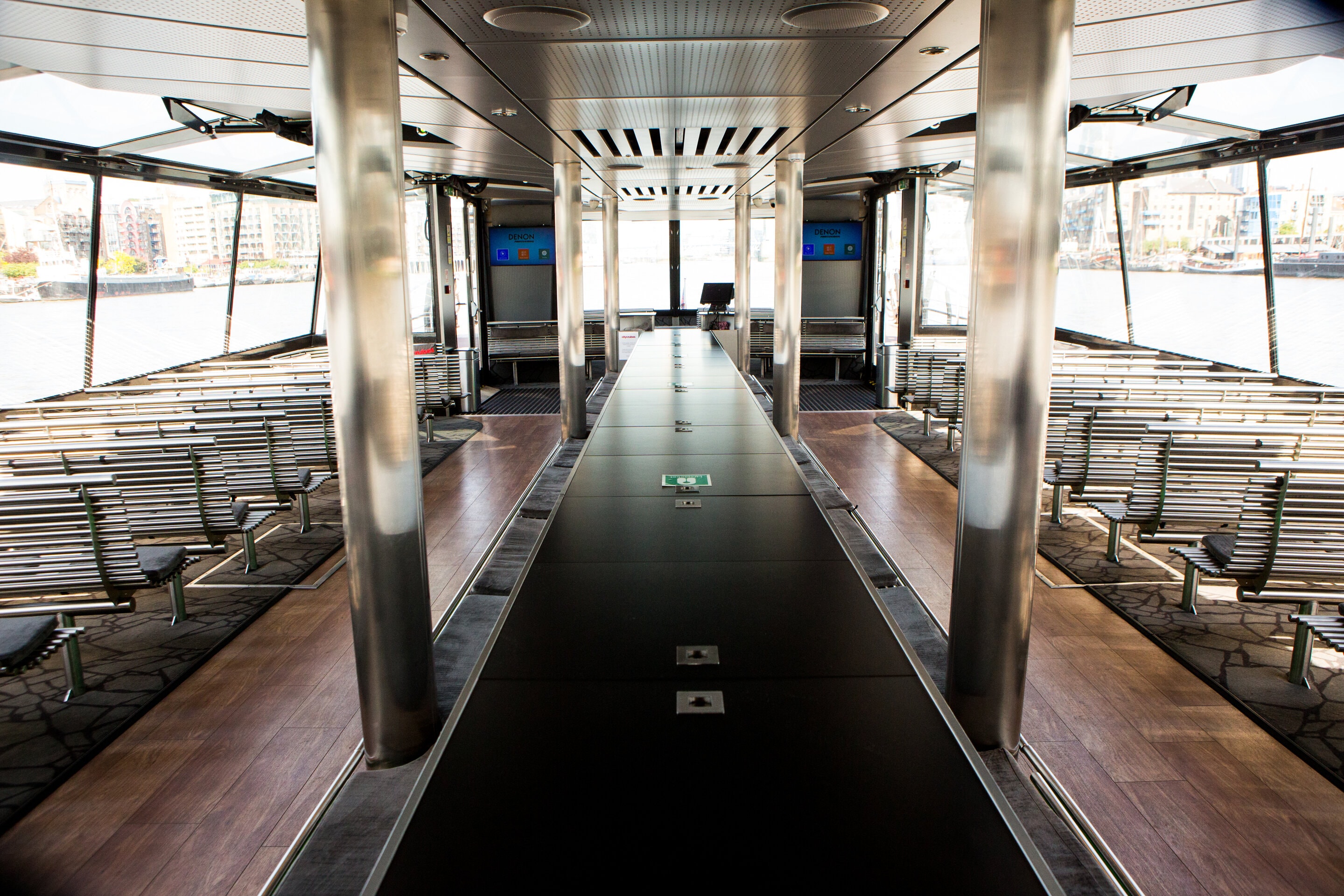 Sleek event space on City Cruises vessel with scenic views for networking and presentations.