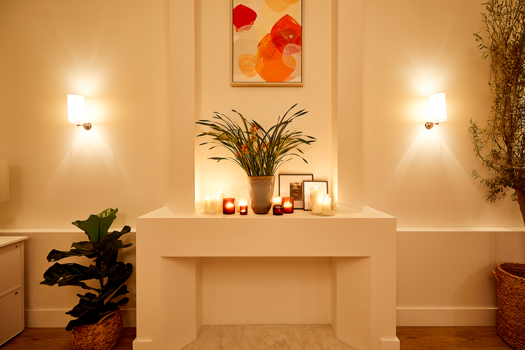 Serene event space with stylish mantel, ideal for intimate gatherings and wellness events.