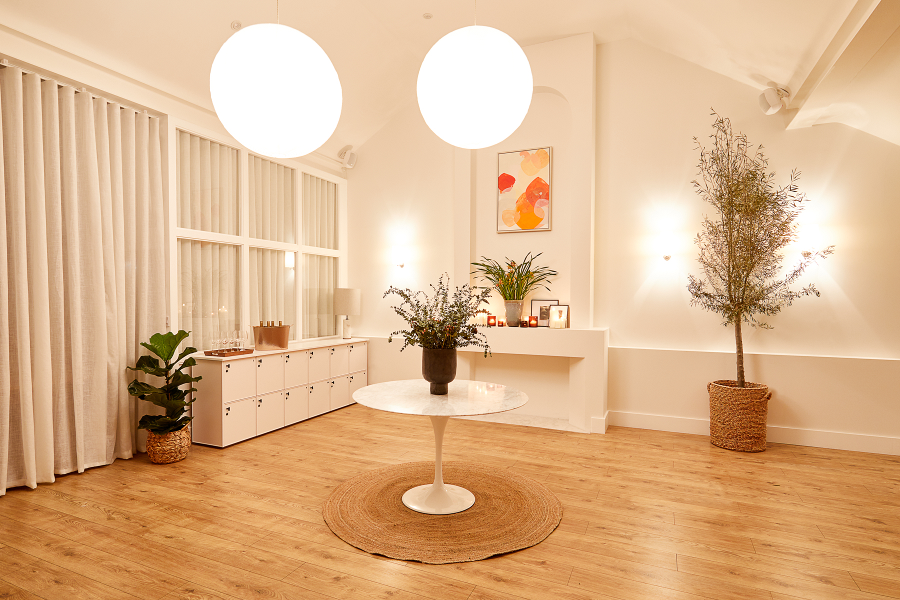 Minimalist event space with soft lighting, ideal for intimate gatherings and workshops.