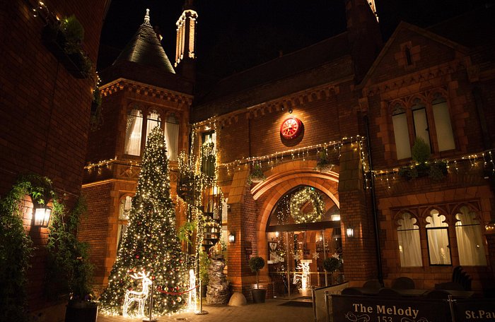 Illuminated Melody Restaurant with Christmas tree, ideal for festive events and gatherings.