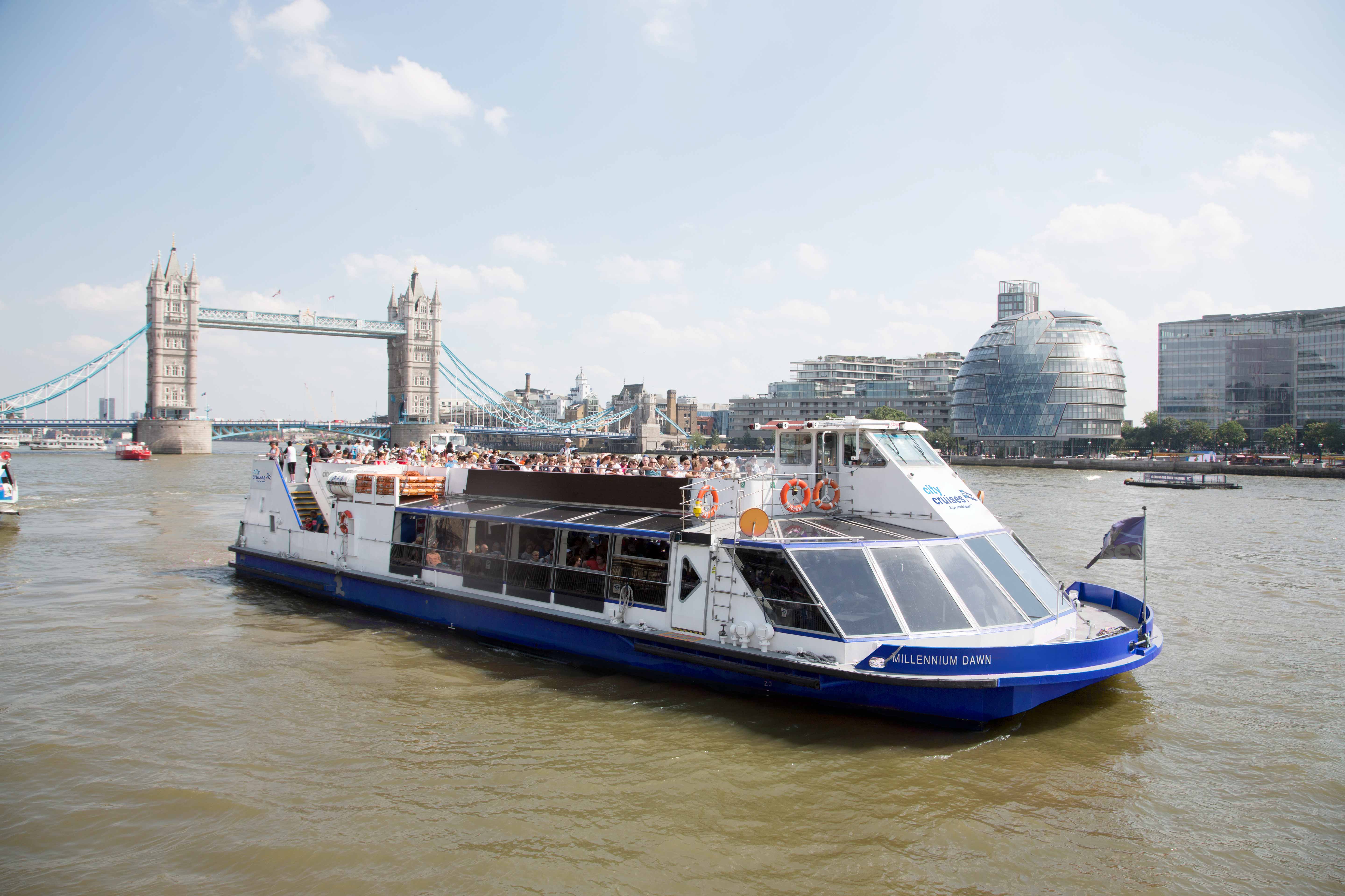 "Spacious event boat on Thames with Tower Bridge, ideal for corporate and social gatherings."