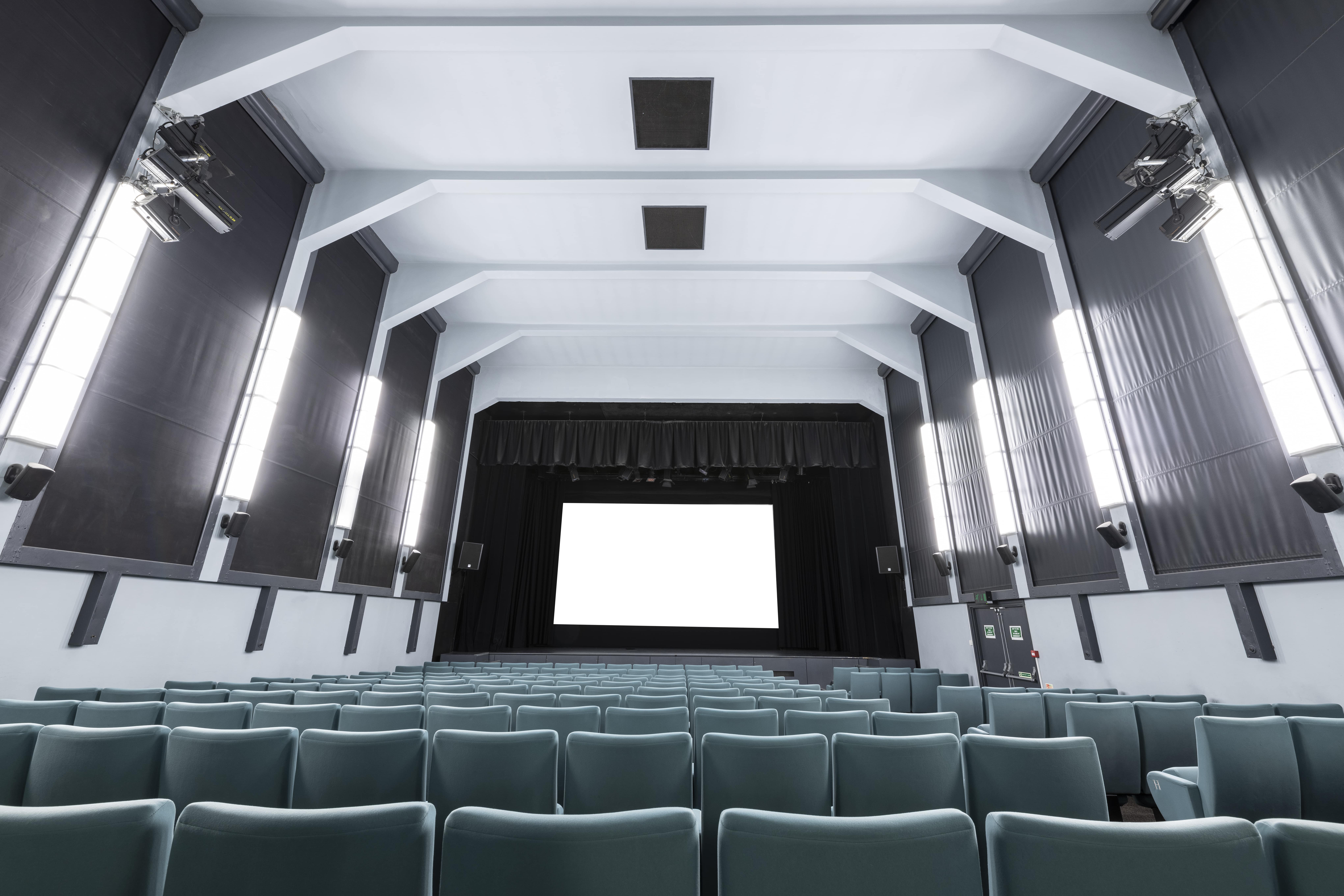 Ciné Lumière auditorium with tiered seating for events and film screenings.