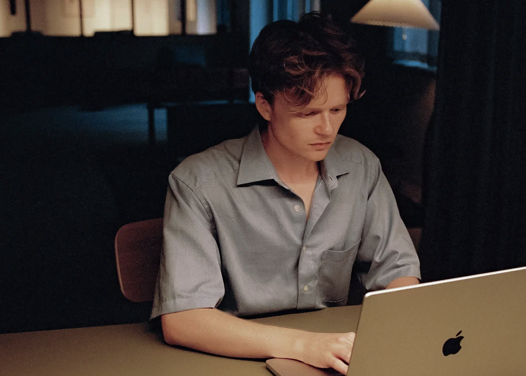 Focused individual working on a laptop in Roco Meeting Room for virtual events.