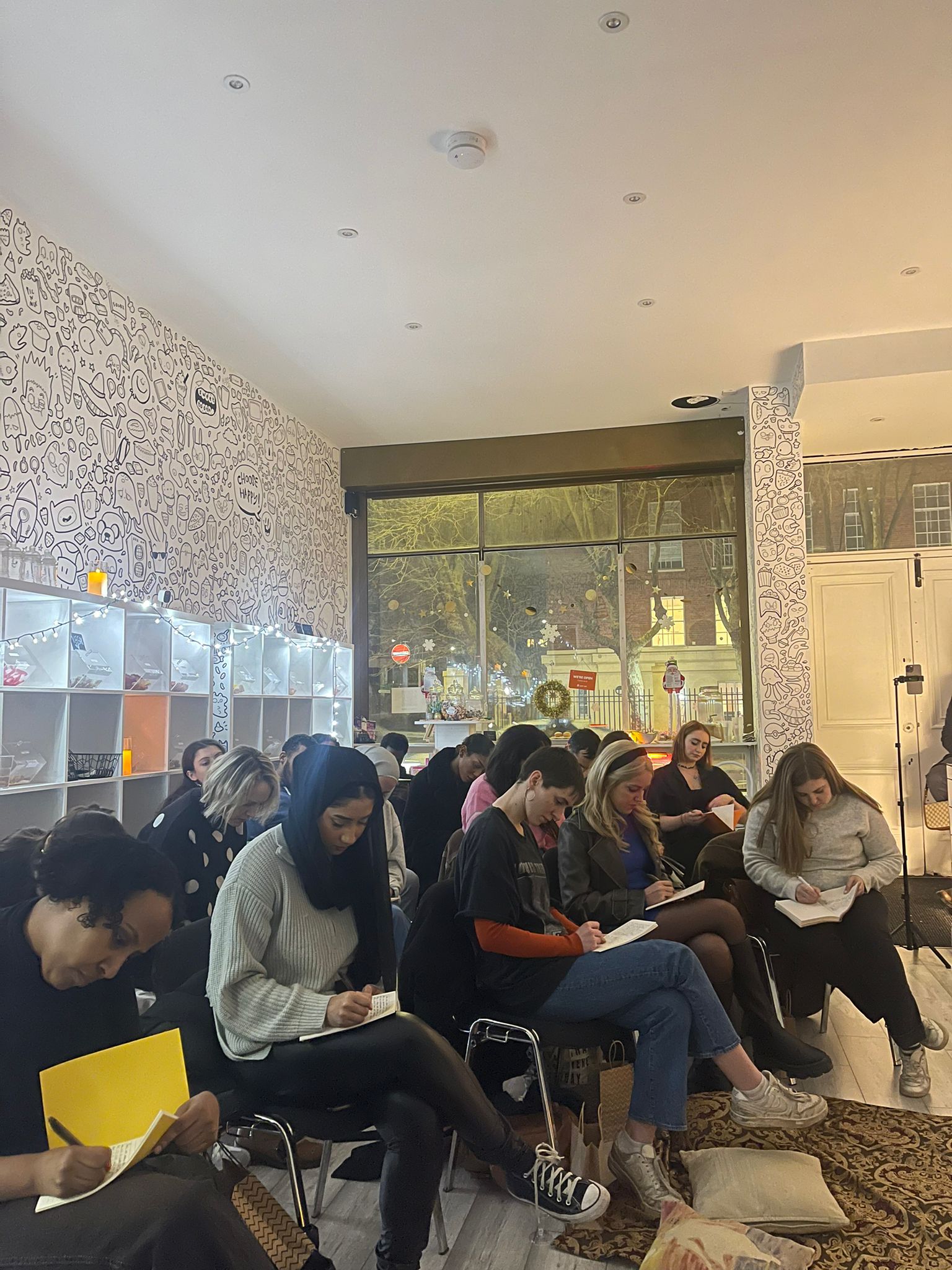 Gallery Show Room workshop with attendees note-taking in a warm, inviting space.