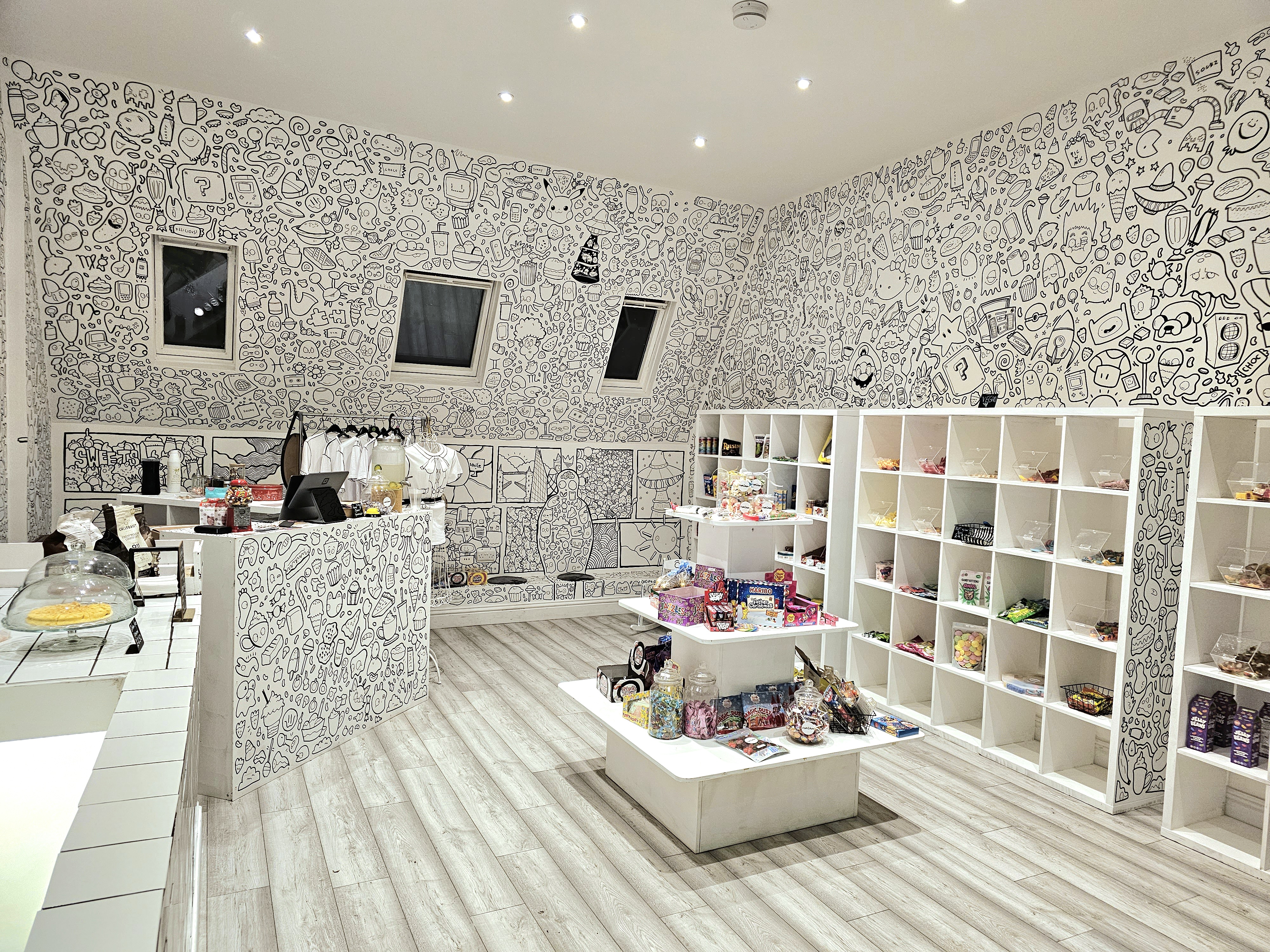 Whimsical event space with hand-drawn art, ideal for pop-up shows and themed gatherings.