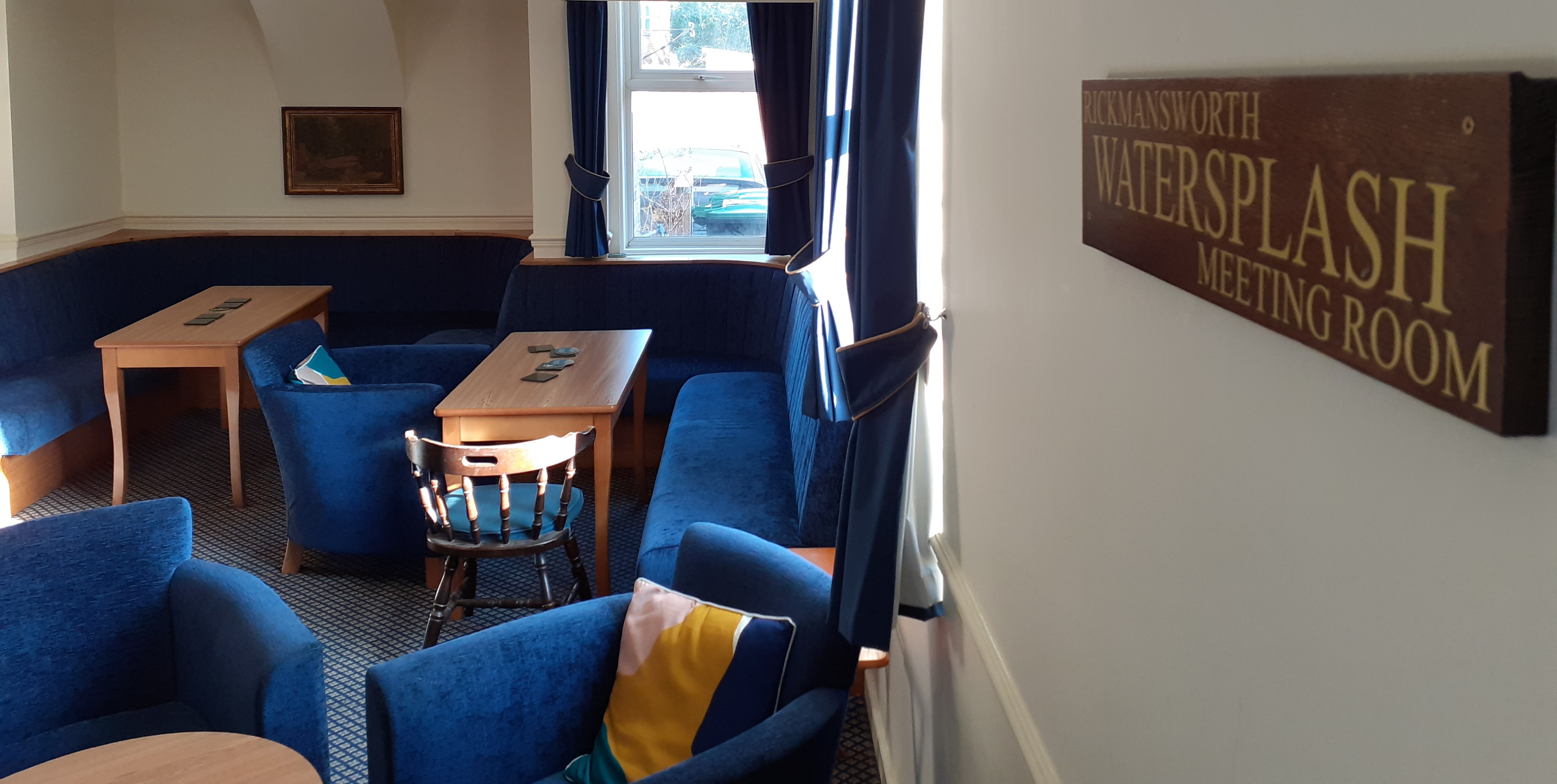 Cozy Rickmansworth Watersplash Meeting Room with blue seating for informal gatherings.