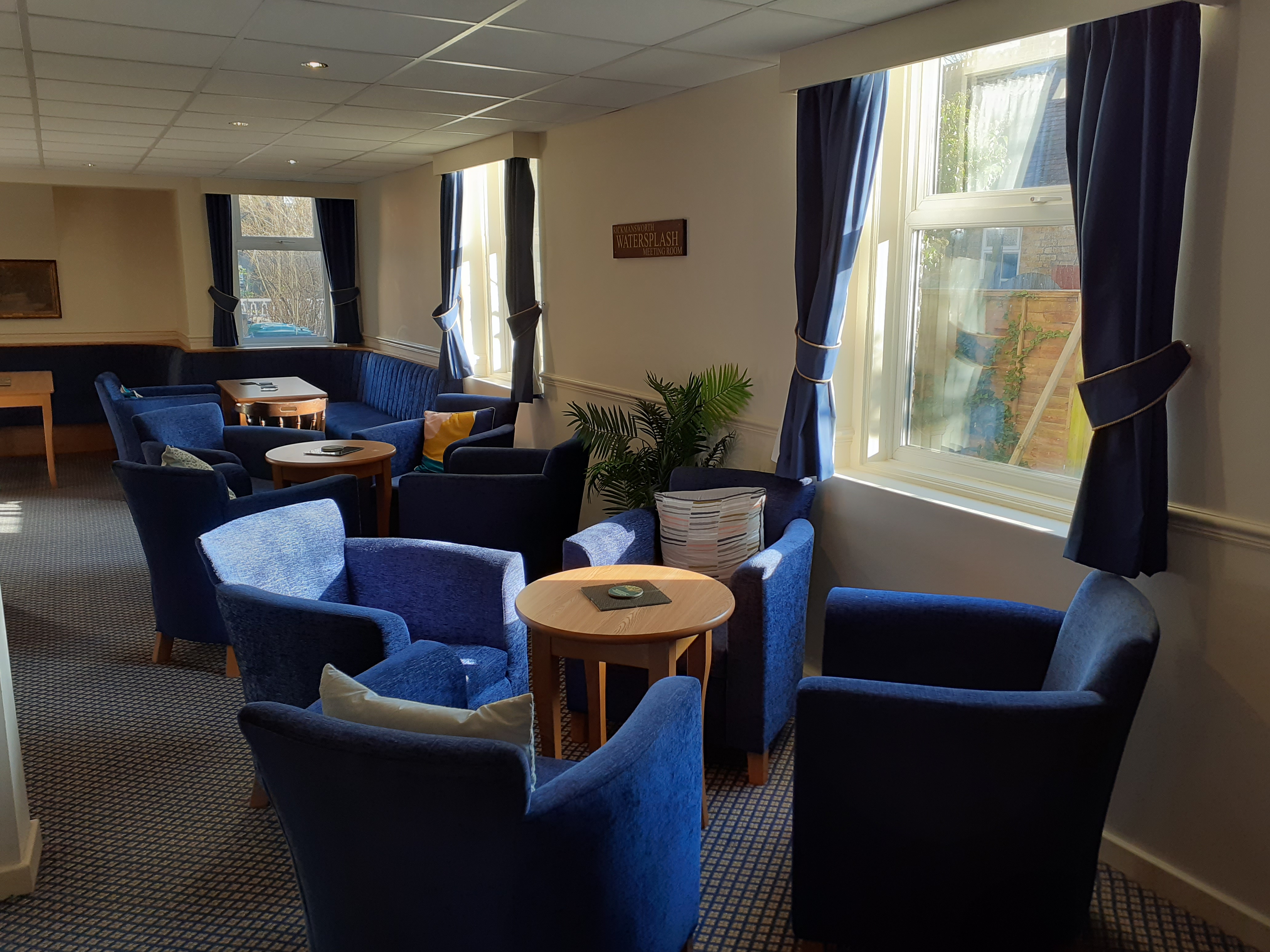 Cozy Rickmansworth Watersplash Meeting Room with blue chairs for informal gatherings.