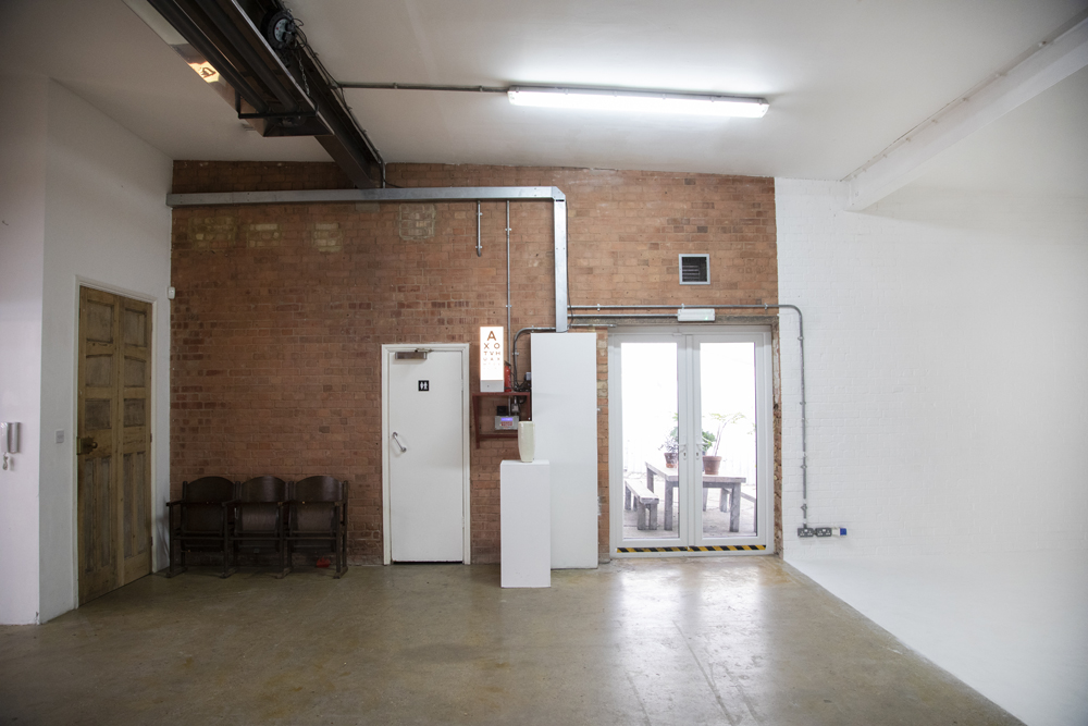 Versatile event space in Bow Bunker, East London with exposed brick wall and natural light.