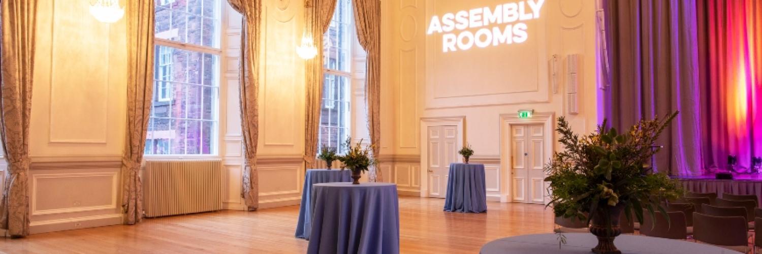 Under-balcony event space with elegant drapery, ideal for corporate events and gatherings.