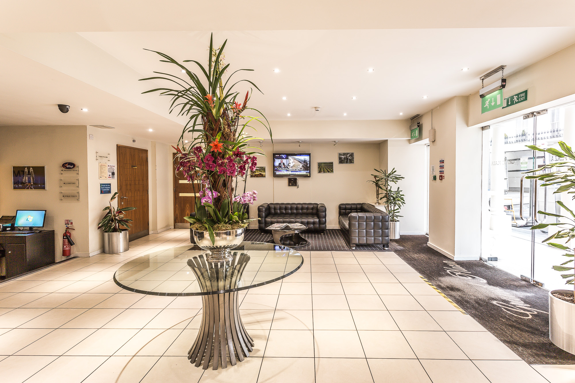 Modern lobby of Grand Plaza Serviced Apartments with elegant floral arrangement, ideal for events.