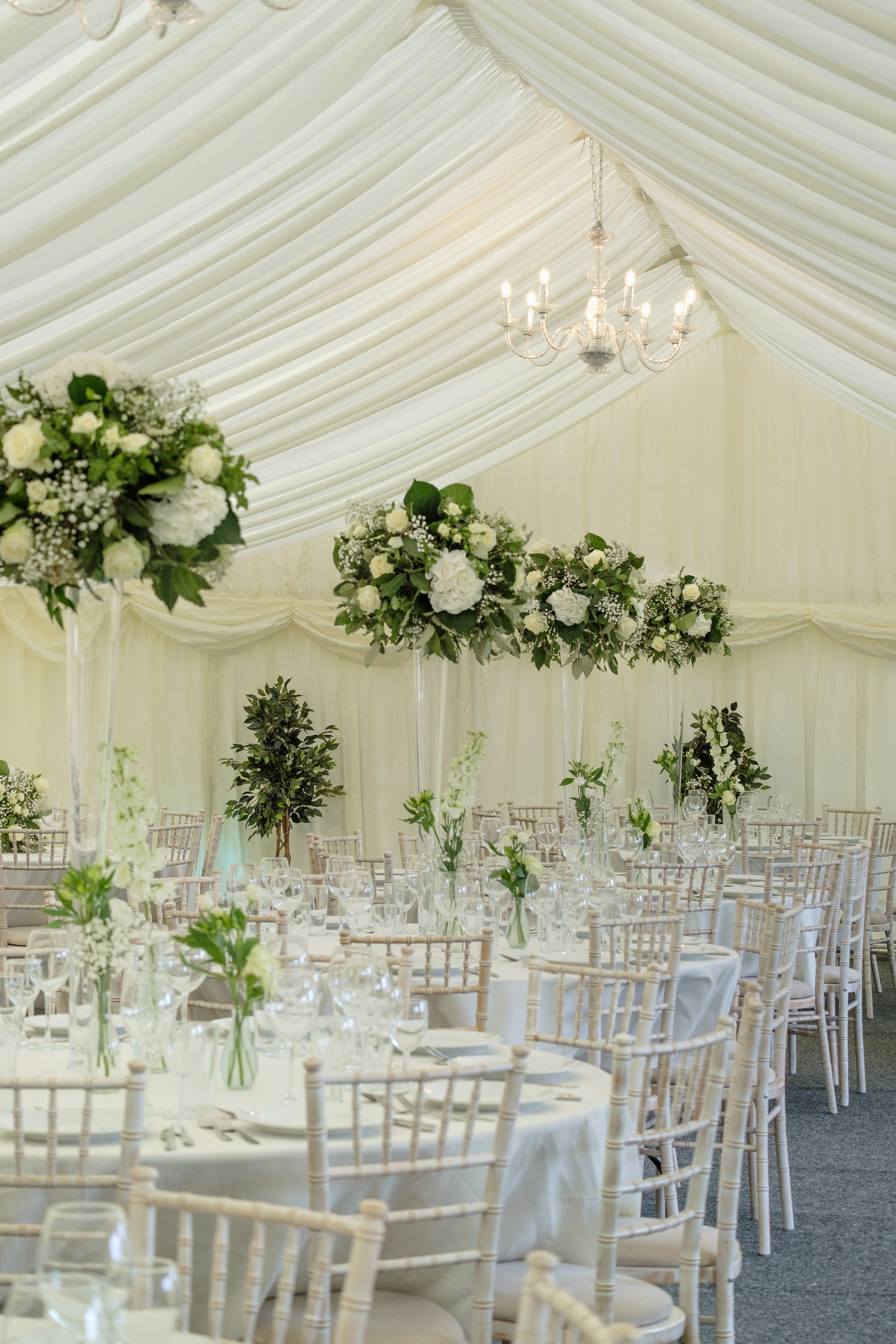 Elegant event space at Parson Lawns with tall floral arrangements for weddings.