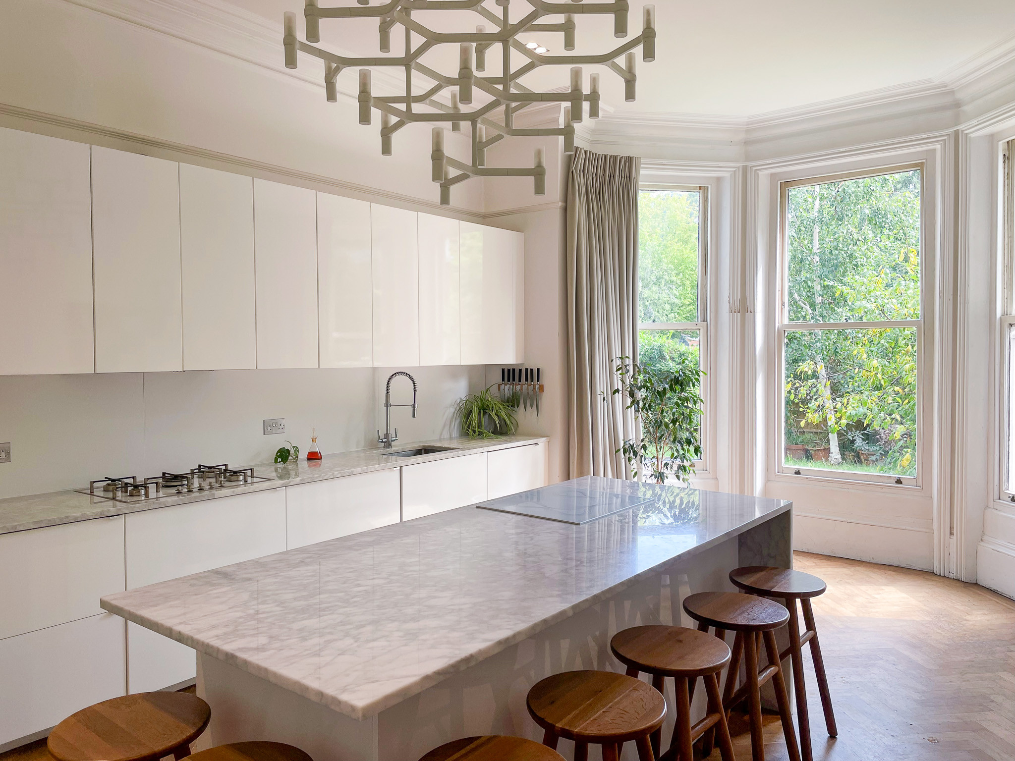 Modern kitchen with marble island, perfect for culinary events and gatherings.
