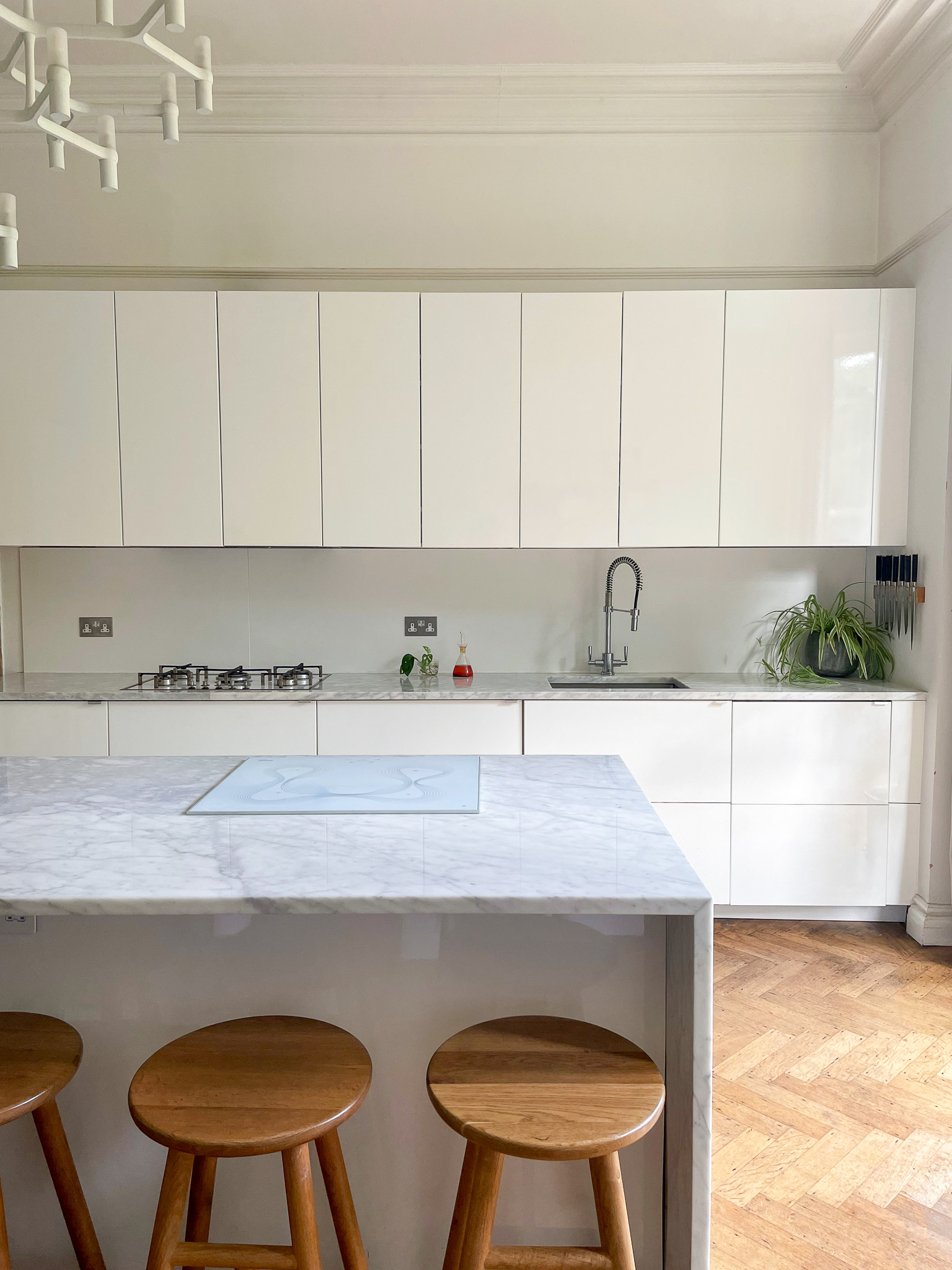 Modern kitchen studio with marble island for culinary events and workshops.