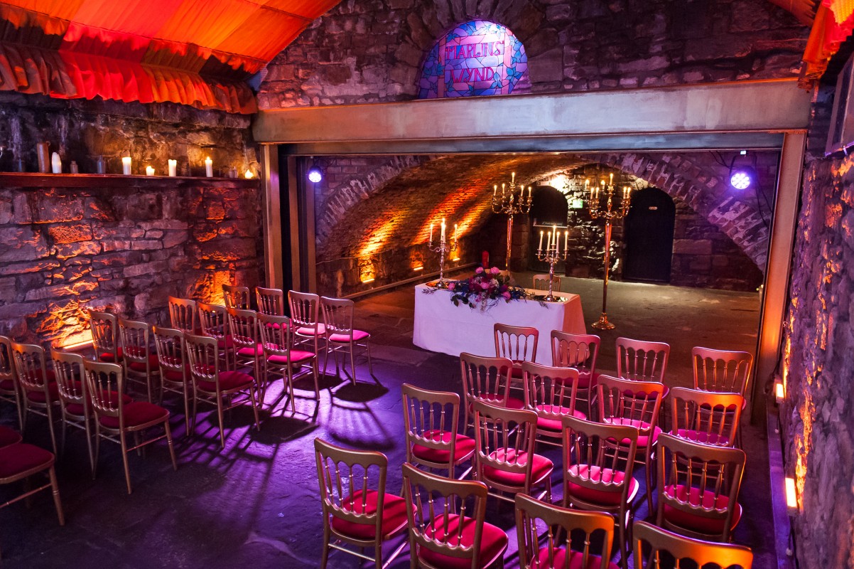 Vaulted Cellars event space with elegant wooden chairs, perfect for weddings and gatherings.