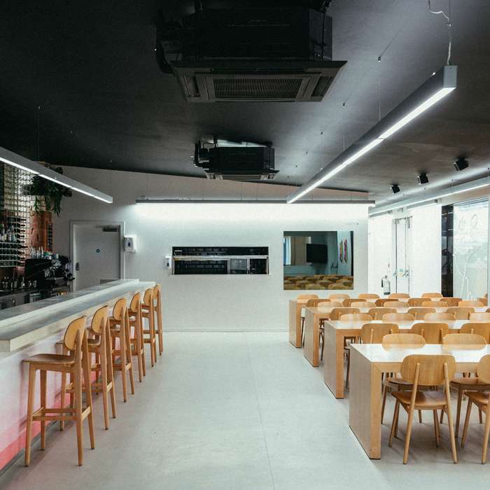 Modern Acid Bar event space with ample seating for workshops and networking.