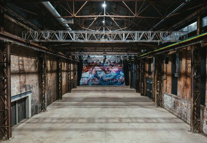Spacious SWG3 warehouse venue with high ceilings for events and conferences.