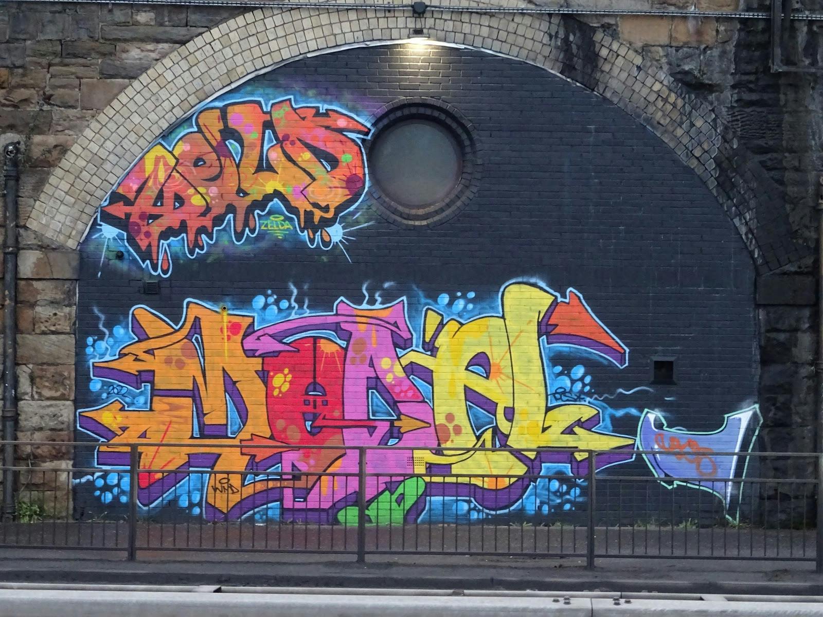 Vibrant graffiti mural on brick wall at SWG3 for urban events and creative workshops.