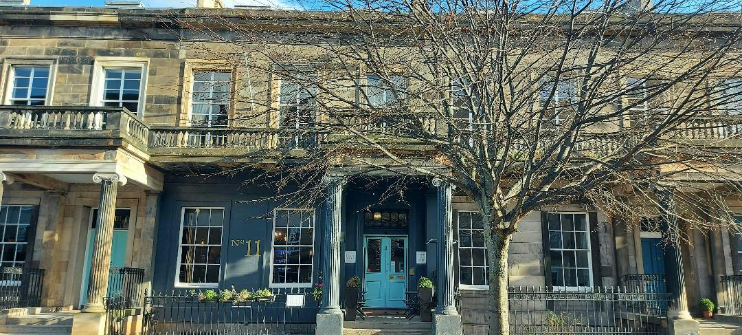 Charming Brasserie venue with blue door, perfect for intimate meetings and events.