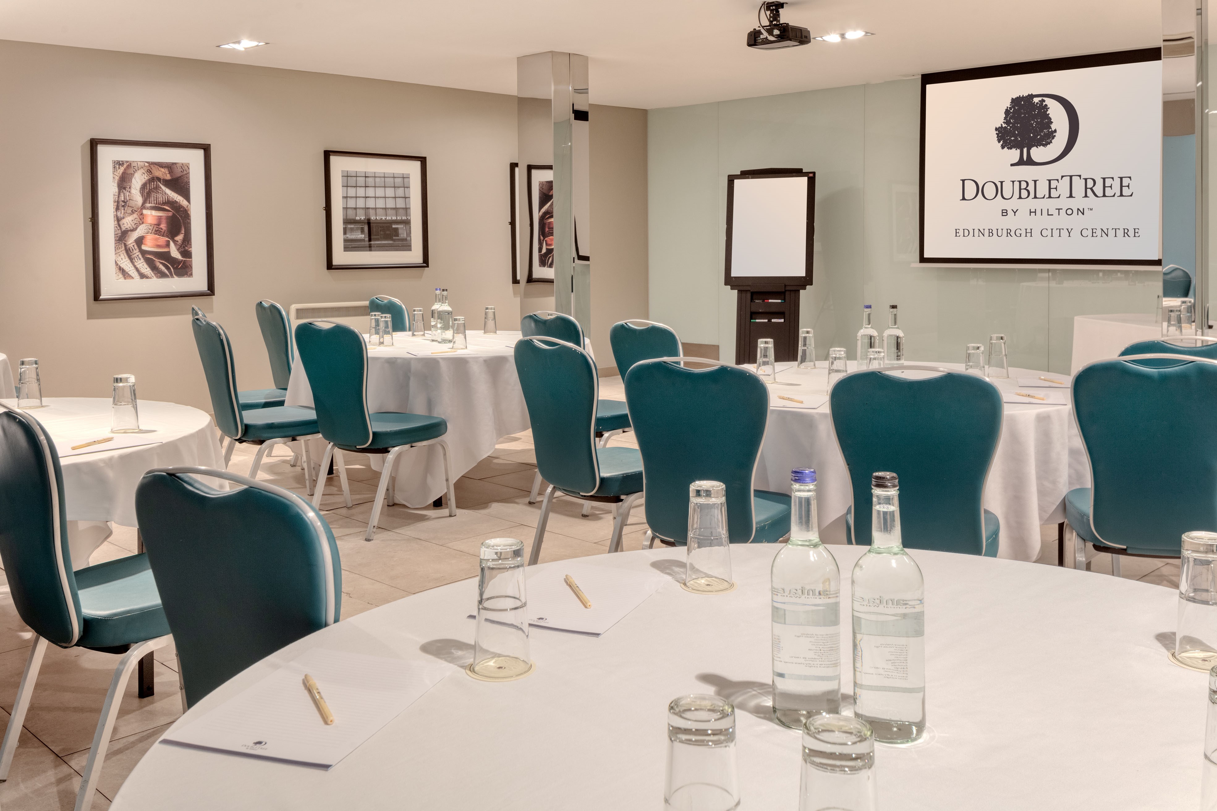 Meeting room at DoubleTree by Hilton Edinburgh with round tables for corporate events.