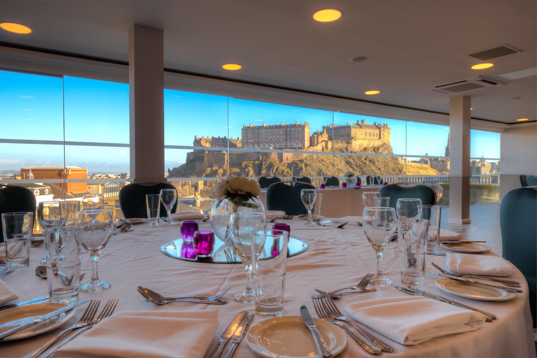 Penthouse dining table with castle view at DoubleTree by Hilton, ideal for upscale events.
