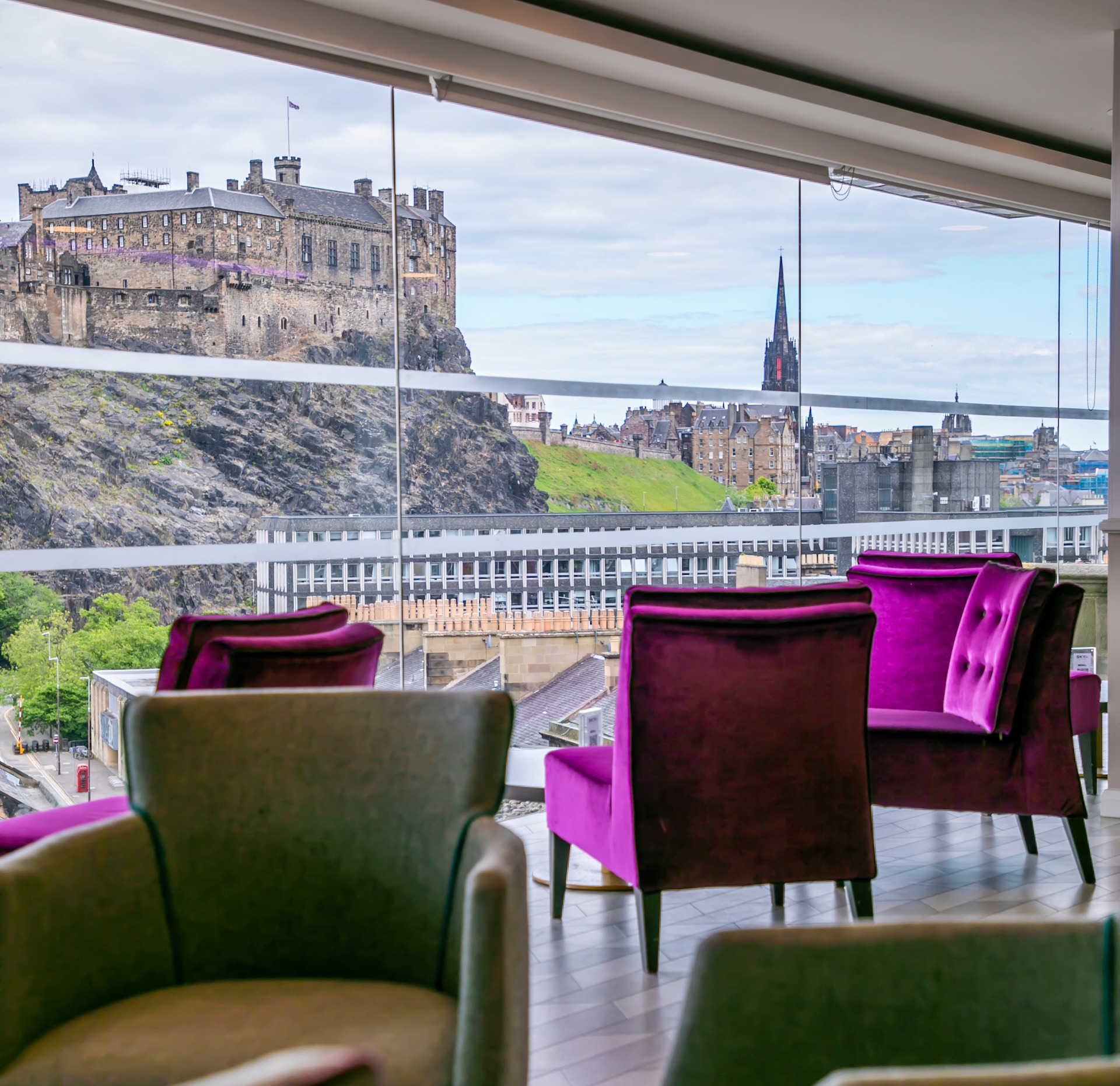SKYBar meeting space with purple chairs and Edinburgh Castle view, perfect for events.