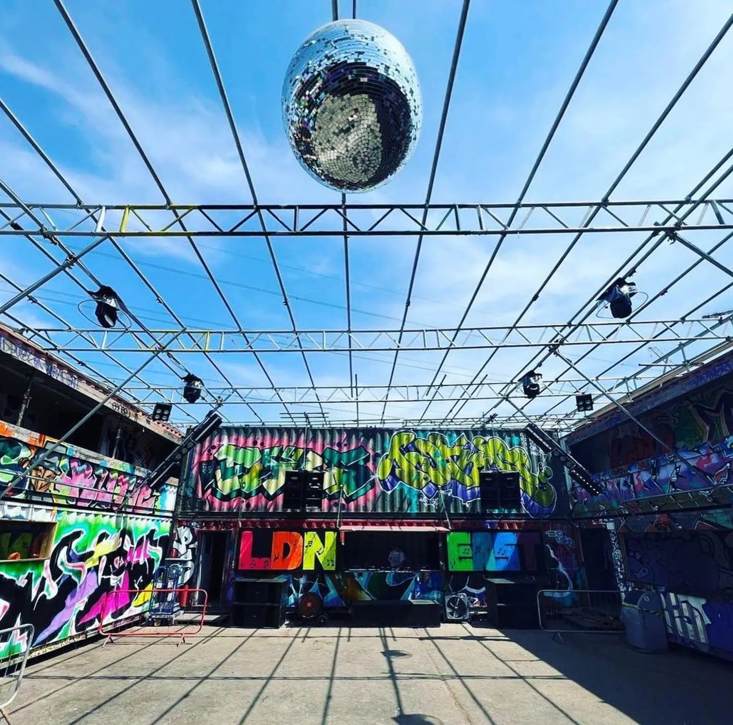 Vibrant urban event space with graffiti and disco ball for creative parties in LDN East.