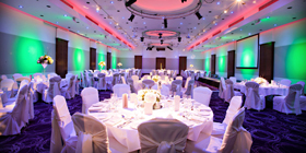 Elegant banquet hall with round tables, ideal for corporate events and gatherings.