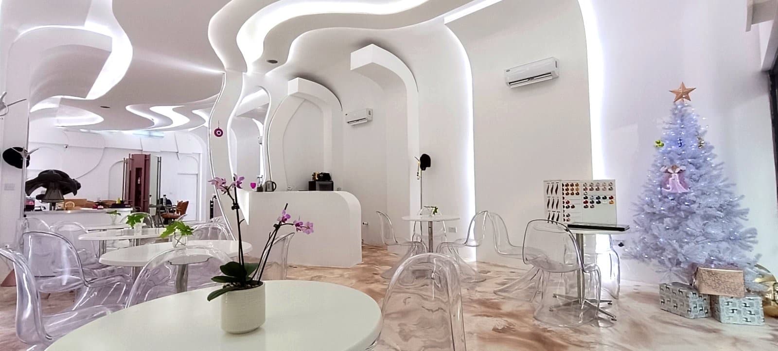 Modern minimalist event space with sleek white walls, ideal for meetings and networking.
