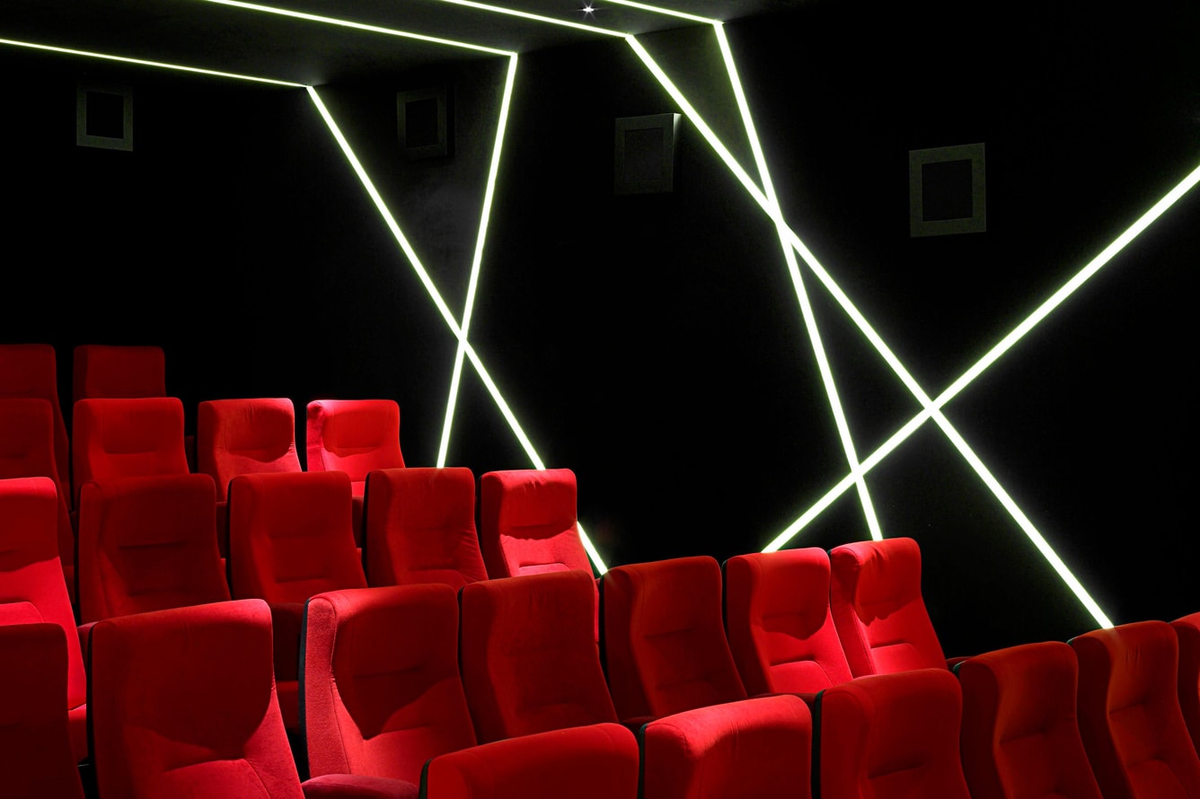 Modern Screening Room in W London with plush red seating for exclusive events.